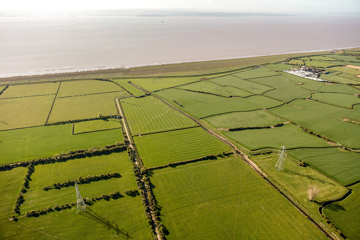 Looking south over Collister Pill and the medieval sea wall (from bottom right, diagonally towards sea). The old sea wall divides the more modern planned landscape to the east (left) from the older unplanned landscape to the west.