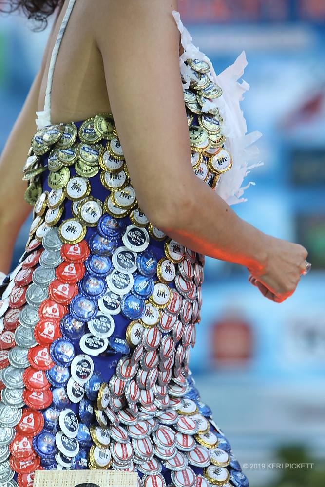 model wearing dress make of bottle caps