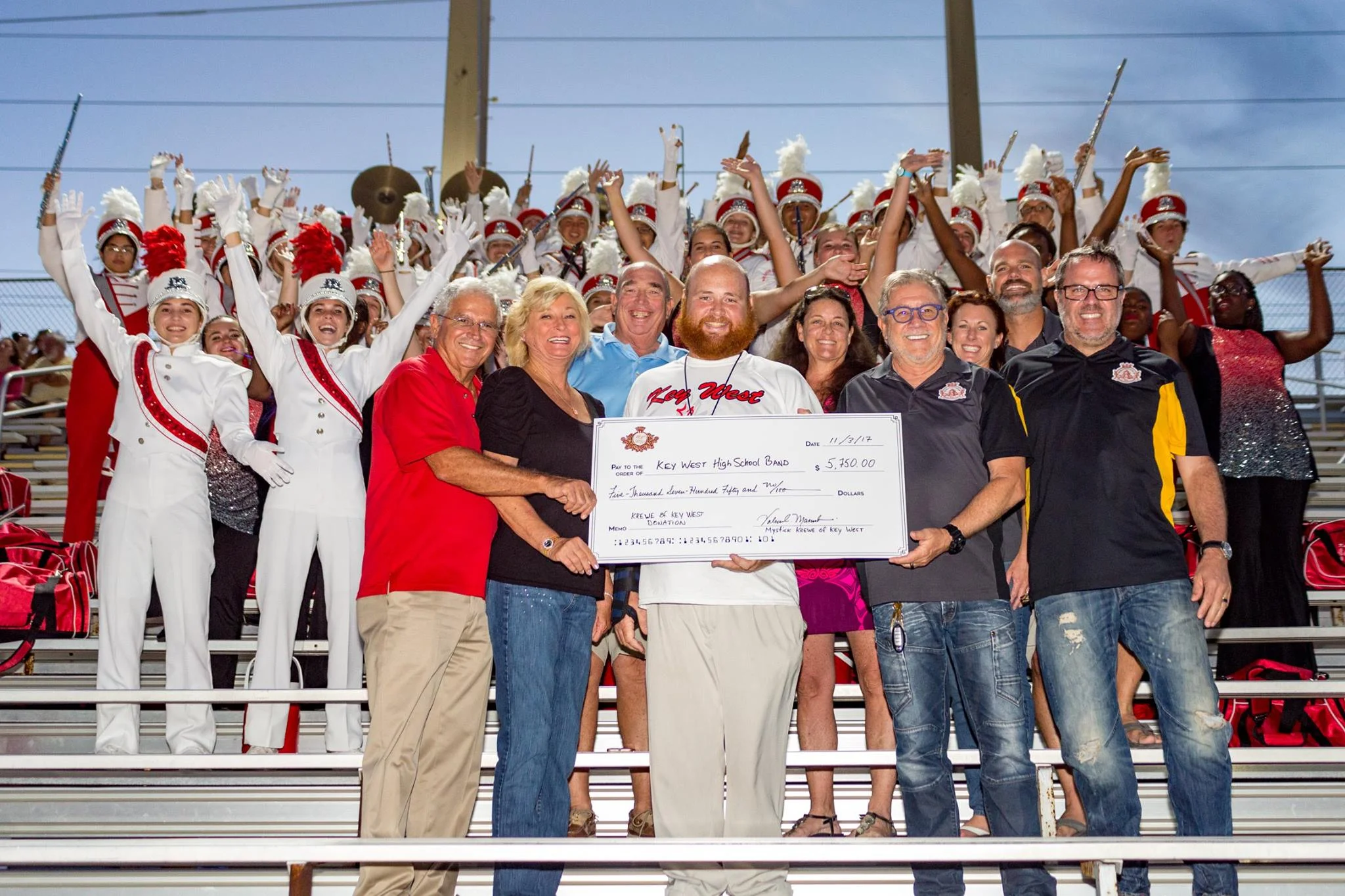 Krewe members present check for $5,750.00 to Key West High School Band