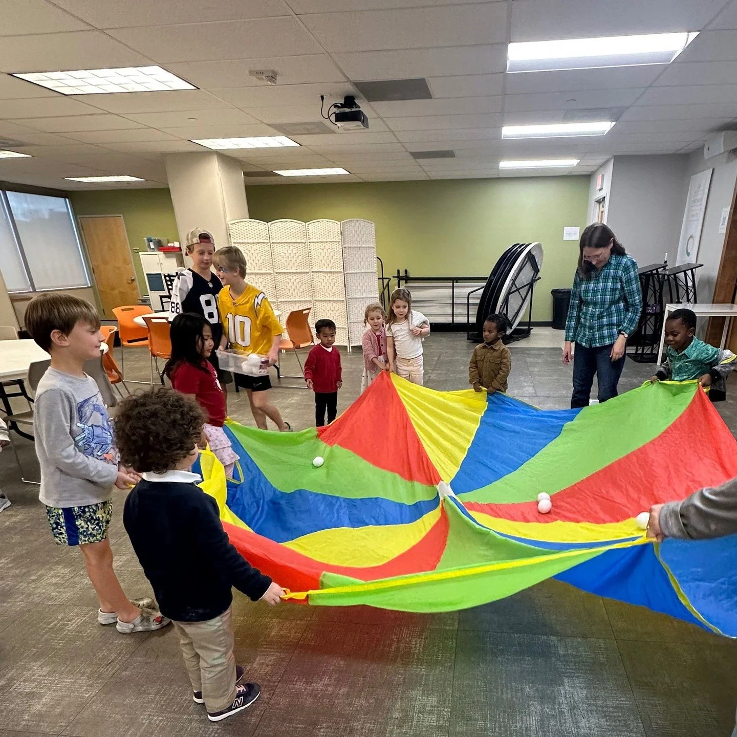 Our preschoolers had the best time playing with a bright, colorful parachute recently! 🌈 Laughter filled the room as little hands worked together to make the colors rise and fall&mdash;learning, moving, and growing all at once.⁠
⁠
Moments like these