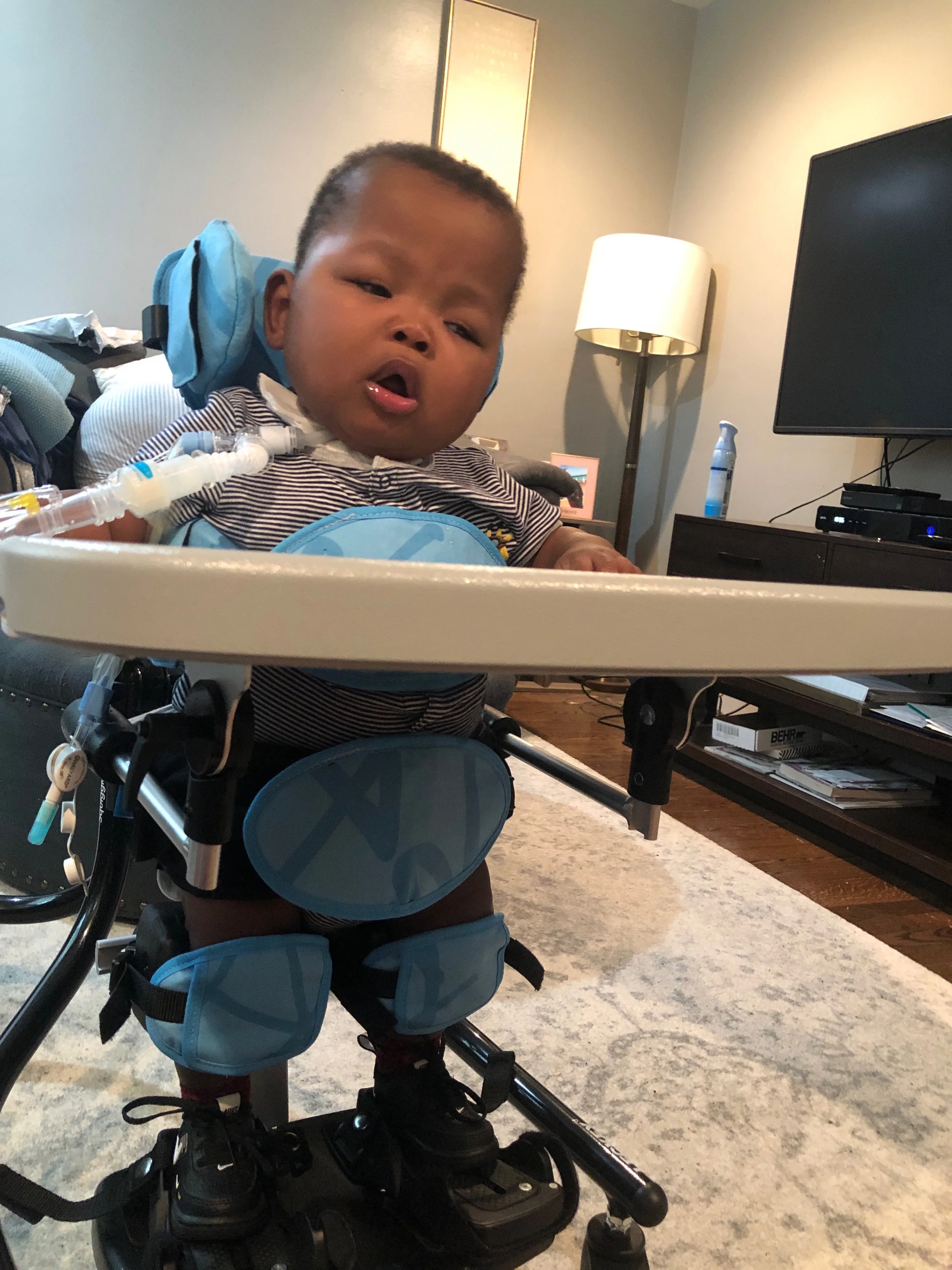Zy’Aire working in his stander to help him learn to put weight on his legs.