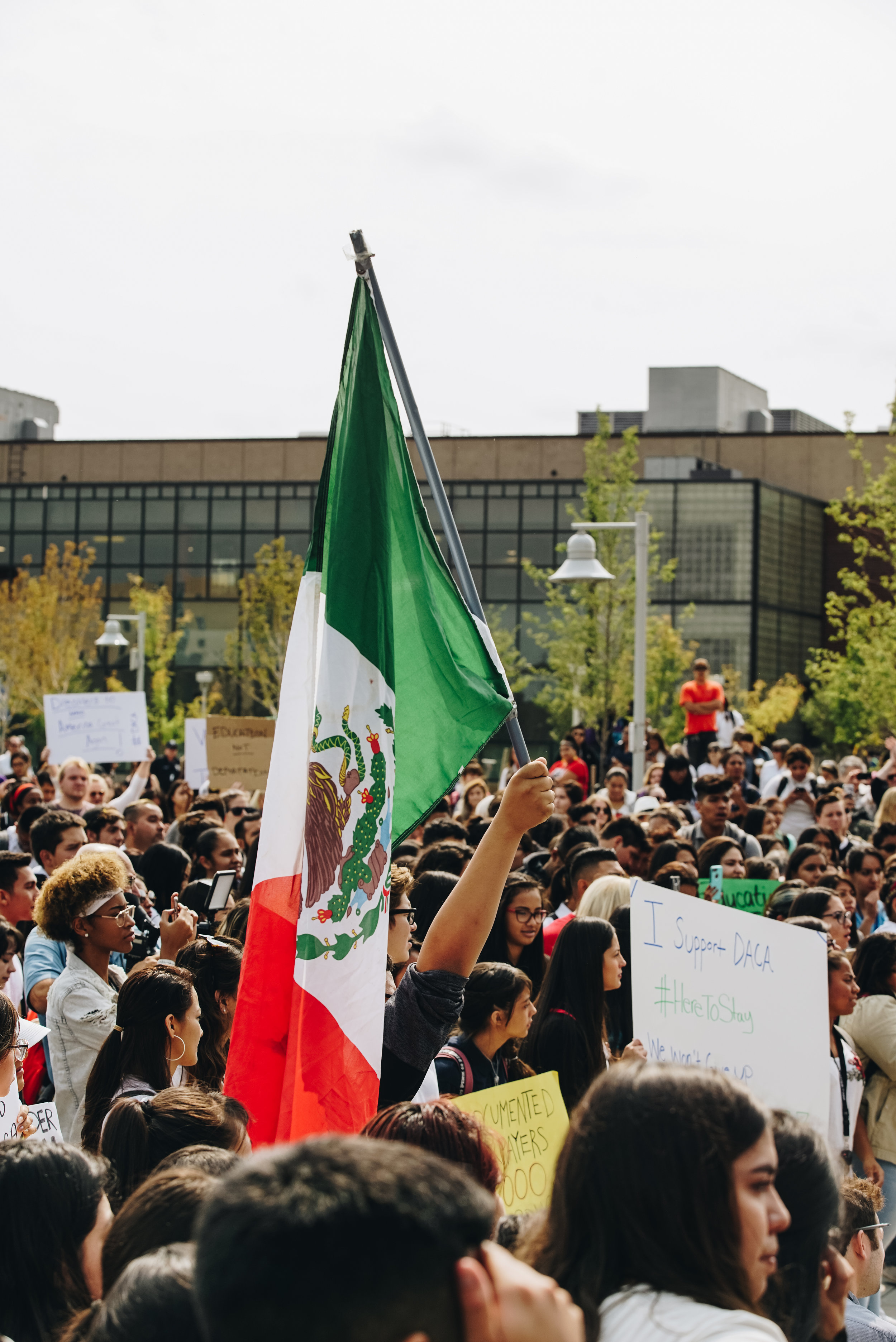 A rally attendee raises a Mexican flag in support of DACA.