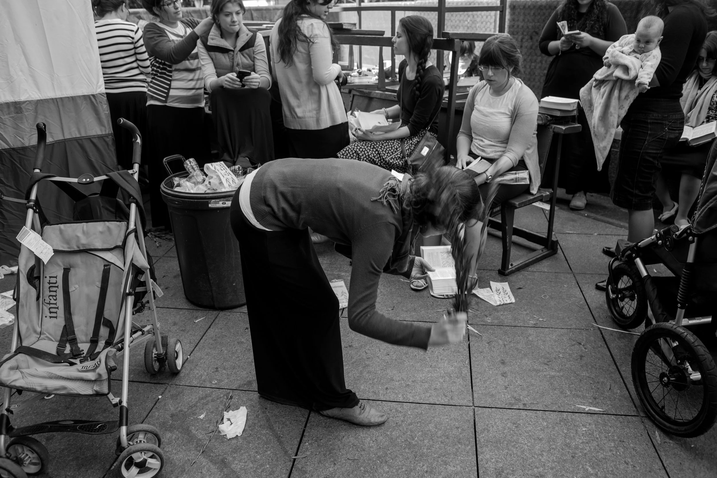 Woman Beating Weeping Willow Branches on the Ground, Part of Sukkot Tradition