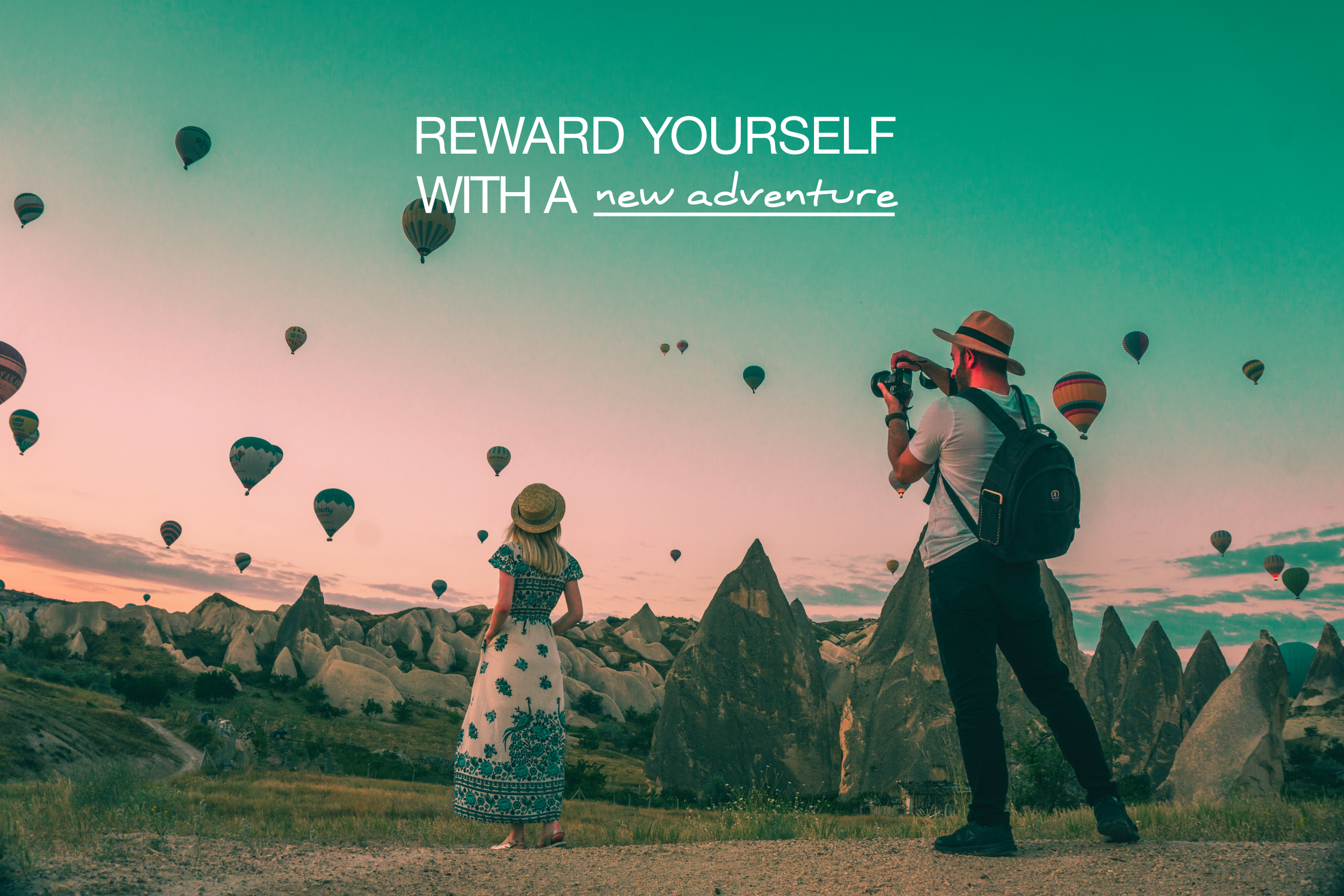 Reward yourself with a new adventure (young couple watching and photographing hot air balloons).