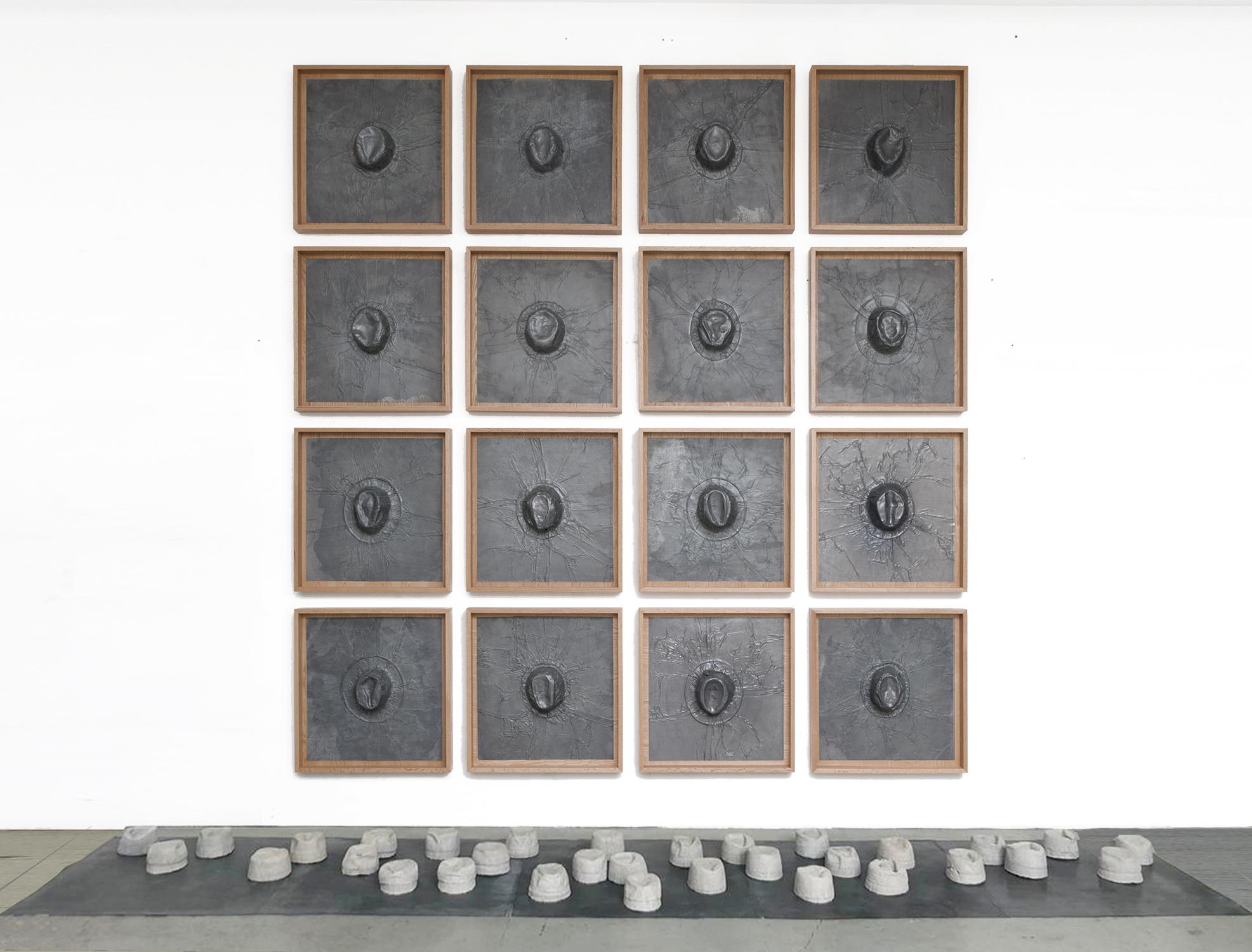  Gray Matter, 2019  16 Hats Belonging to My Father (1905-1978) Embossed in Lead, and 32 Concrete Casts of the Inside of the Hats   197” x 157” x 48”    Materia Gris, 2019   16 Sombreros de Mi Padre (1905 – 1978) Repujados en Plomo y 32 Moldes de Conc