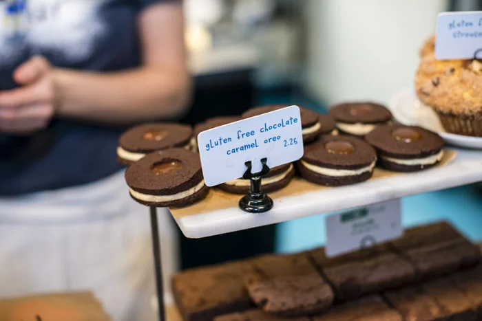 Treats of every size, shape, and color abound at the counter of Flour Bakery + Co, including gluten free options and WHOLEflour goods that are baked with health in mind. Photograph by Lydia Carmichael/The Thirty-One Percent