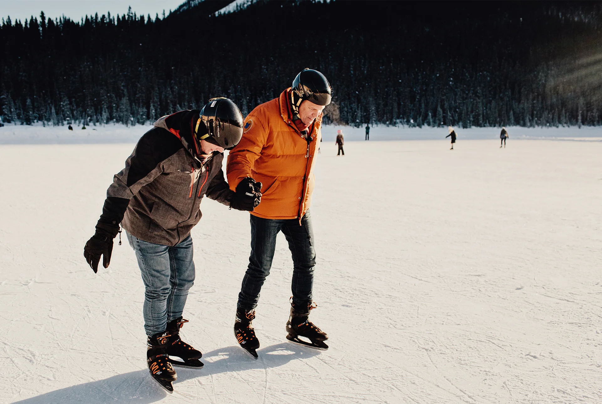 Rob Scheer and his husband Reece ice skating on Lake Louise in Alberta, Canada