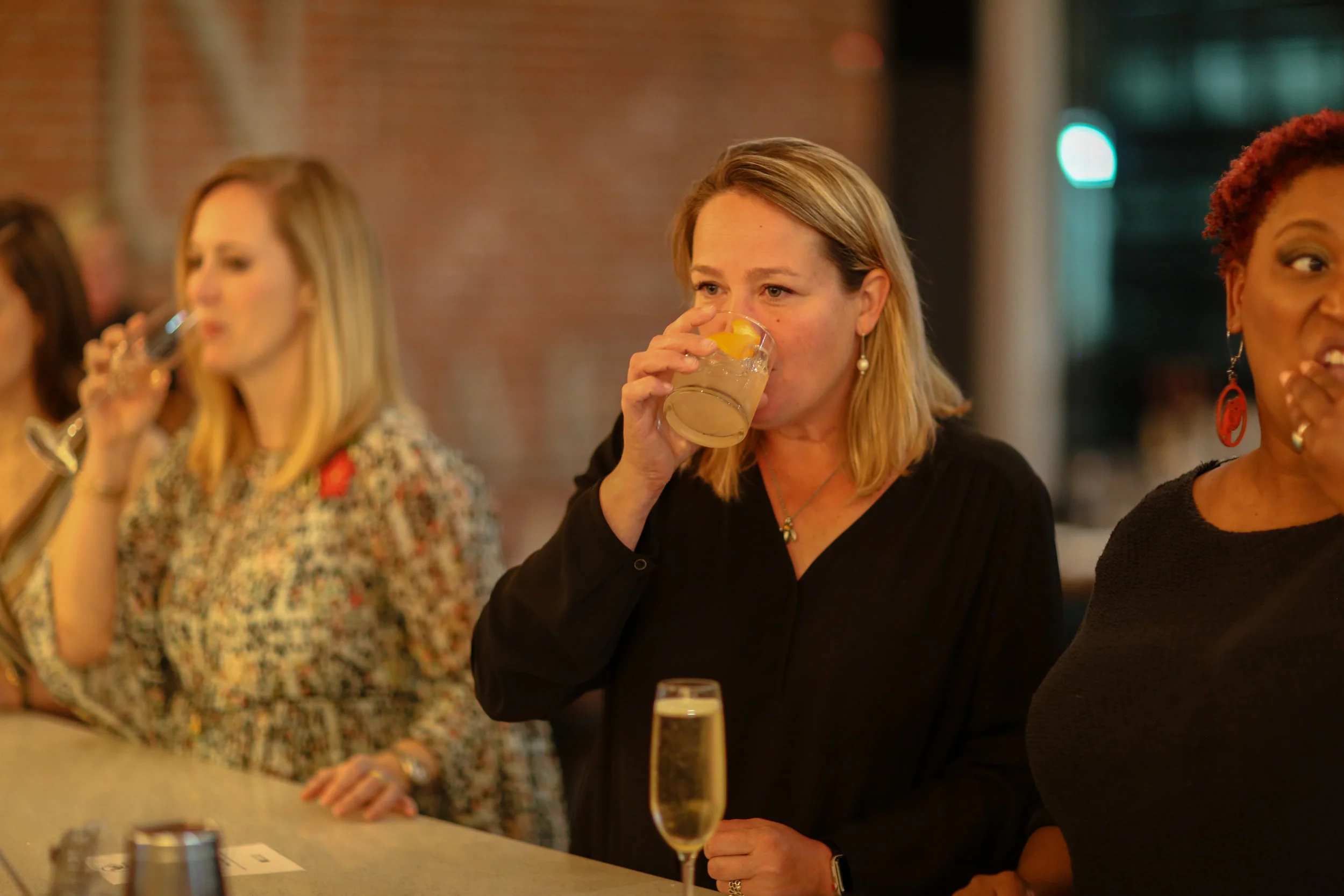 Guests sipping on specialty "Money Moves" cocktail.