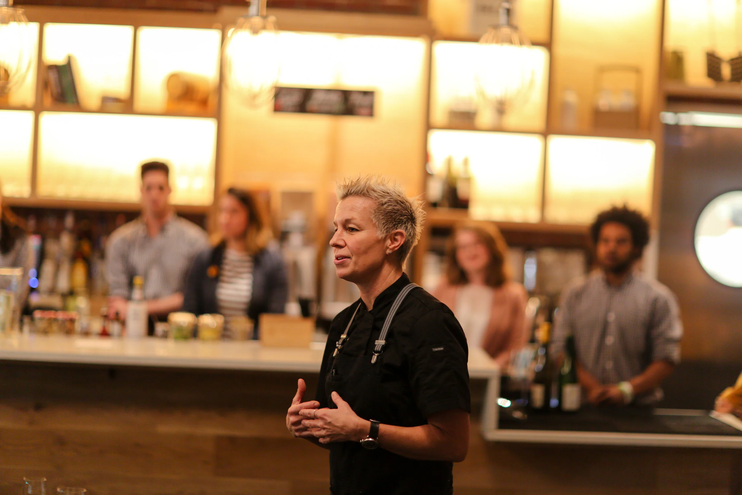 Chef Elizabeth Falkner presenting her first course to guests.