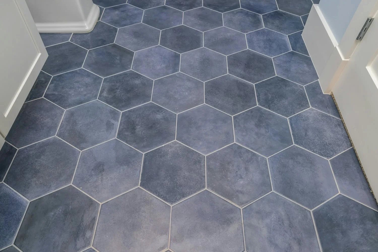 A BEautiful grey-blue hexagonal tile floor with white walls