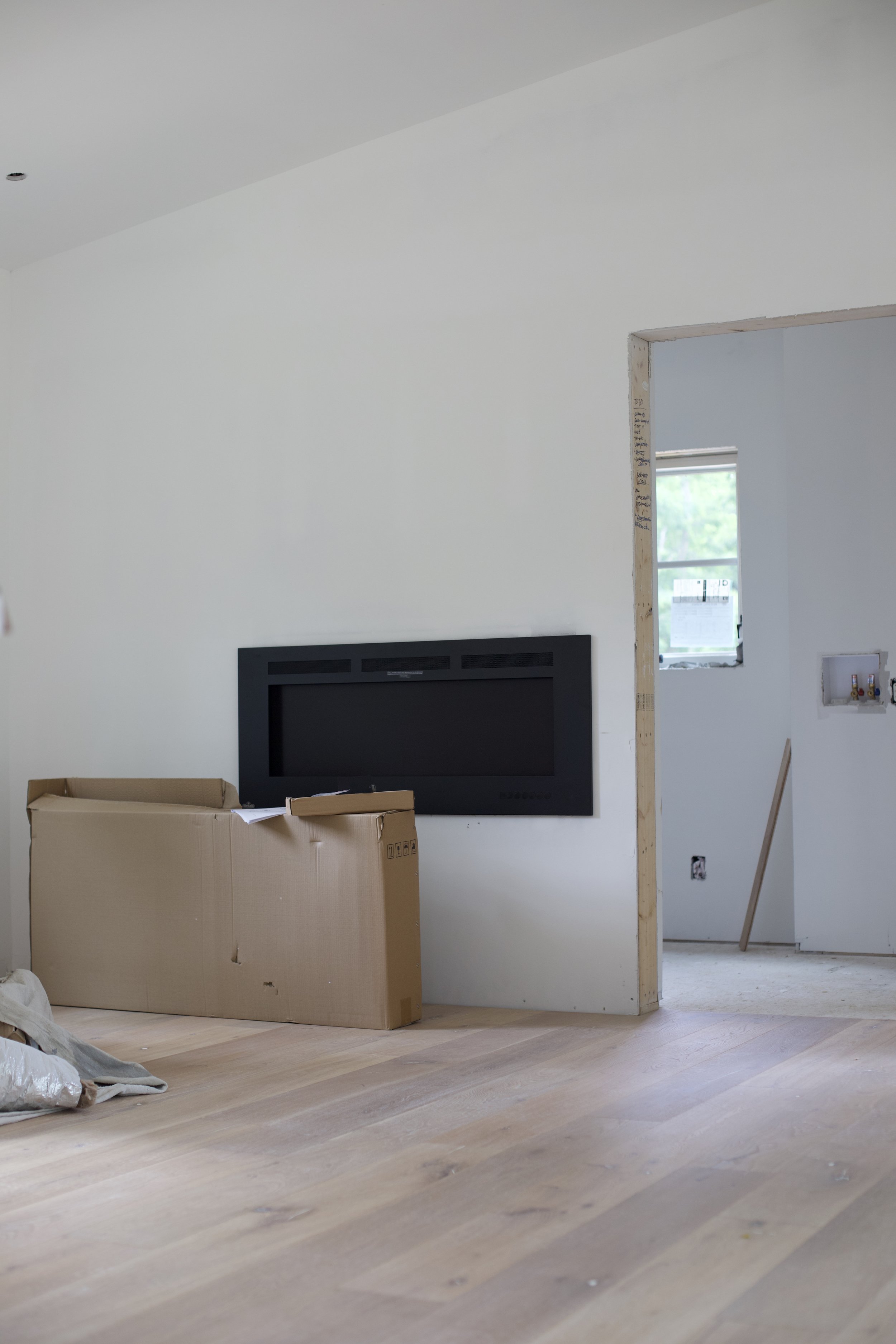 fire place & living room, with door way to laundry room. 