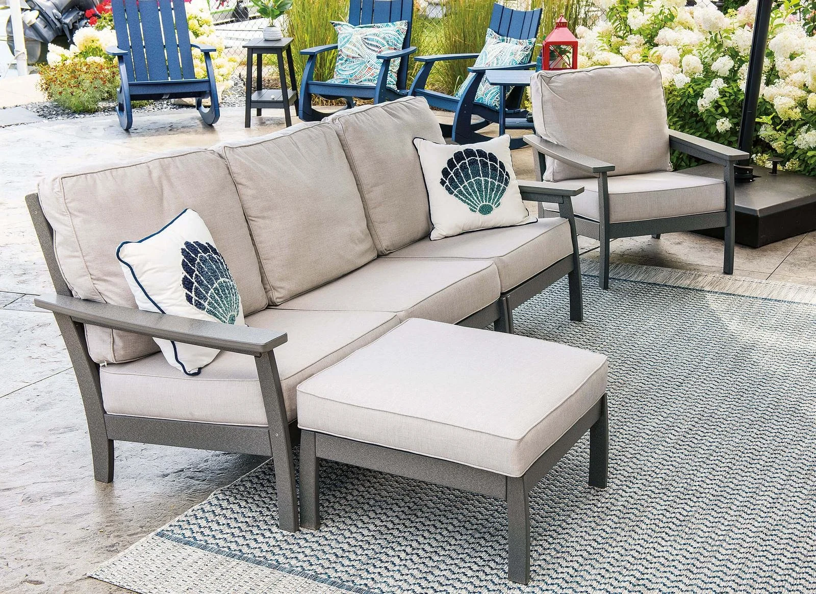 EC-Woods-Calistoga-Outdoor-Poly-Sofa-and-Ottoman-Dark-Gray-Sunbrella-Natural-Cushions.jpeg