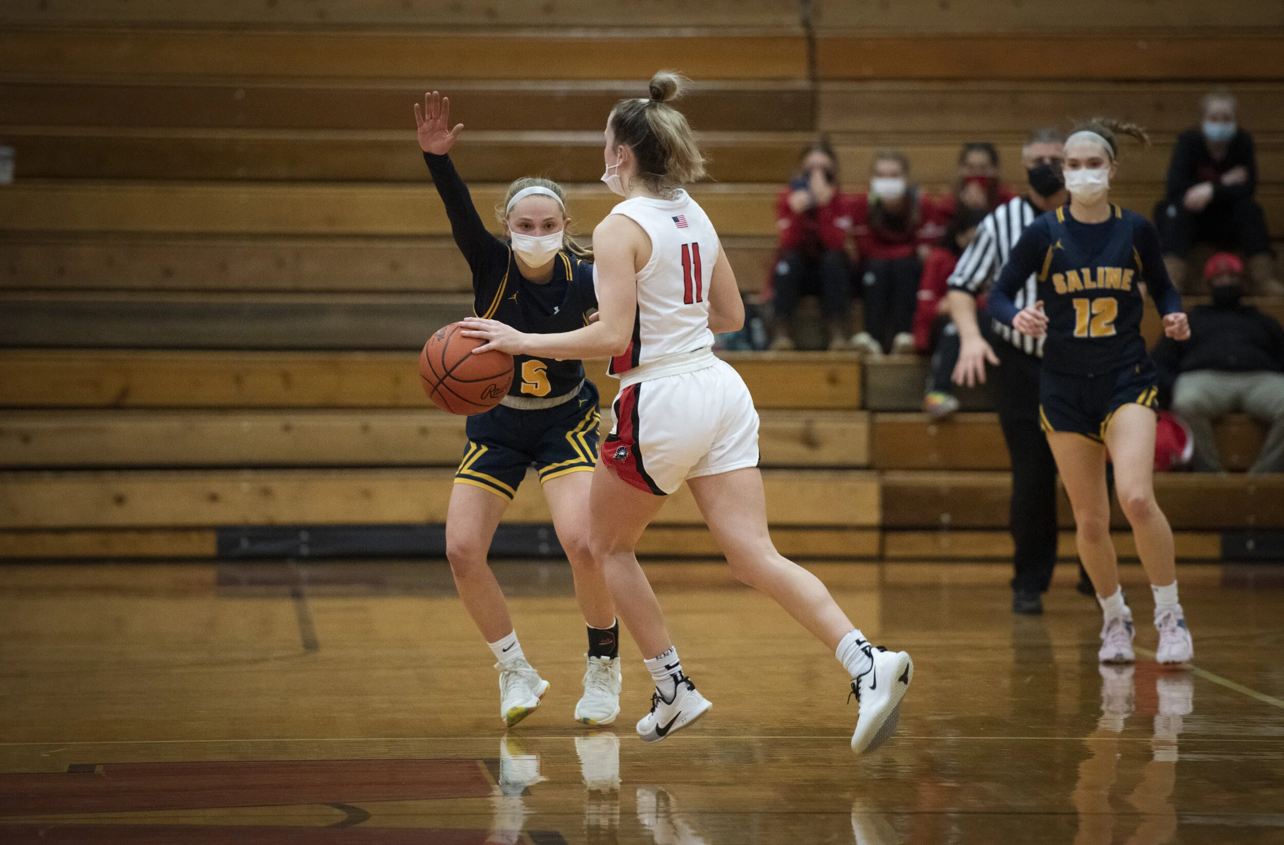  Saline’s Kate Stemmer (5) defends while her sister Ella keeps other Monroe players away from the basket during a game in Monroe on Friday, March 5, 2021. Saline beat Monroe 64-52. The sisters work together on the court. They play together in sync. I