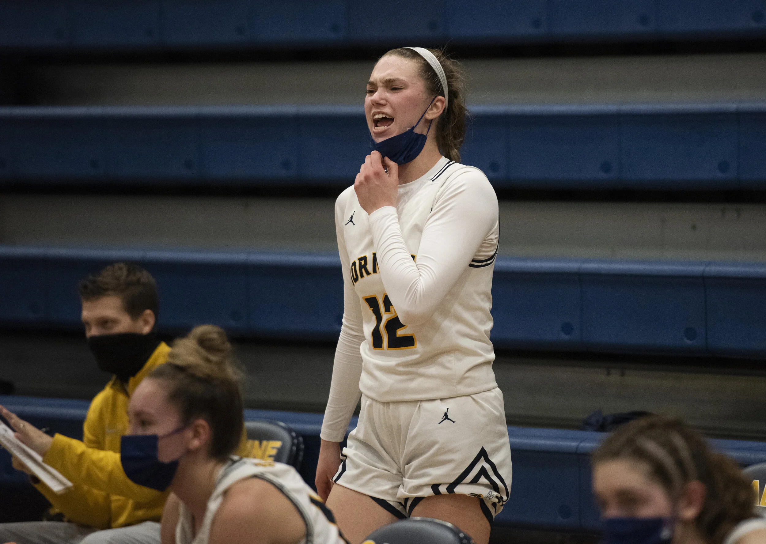  Ella Stemmer yells from the bench in a game against Ypsilanti Lincoln at home on Thursday, March 11, 2021.   The team was doing well, and so Stemmer was pulled out of the game to give other girls a chance to play but that didn’t stop her spirit. “I 