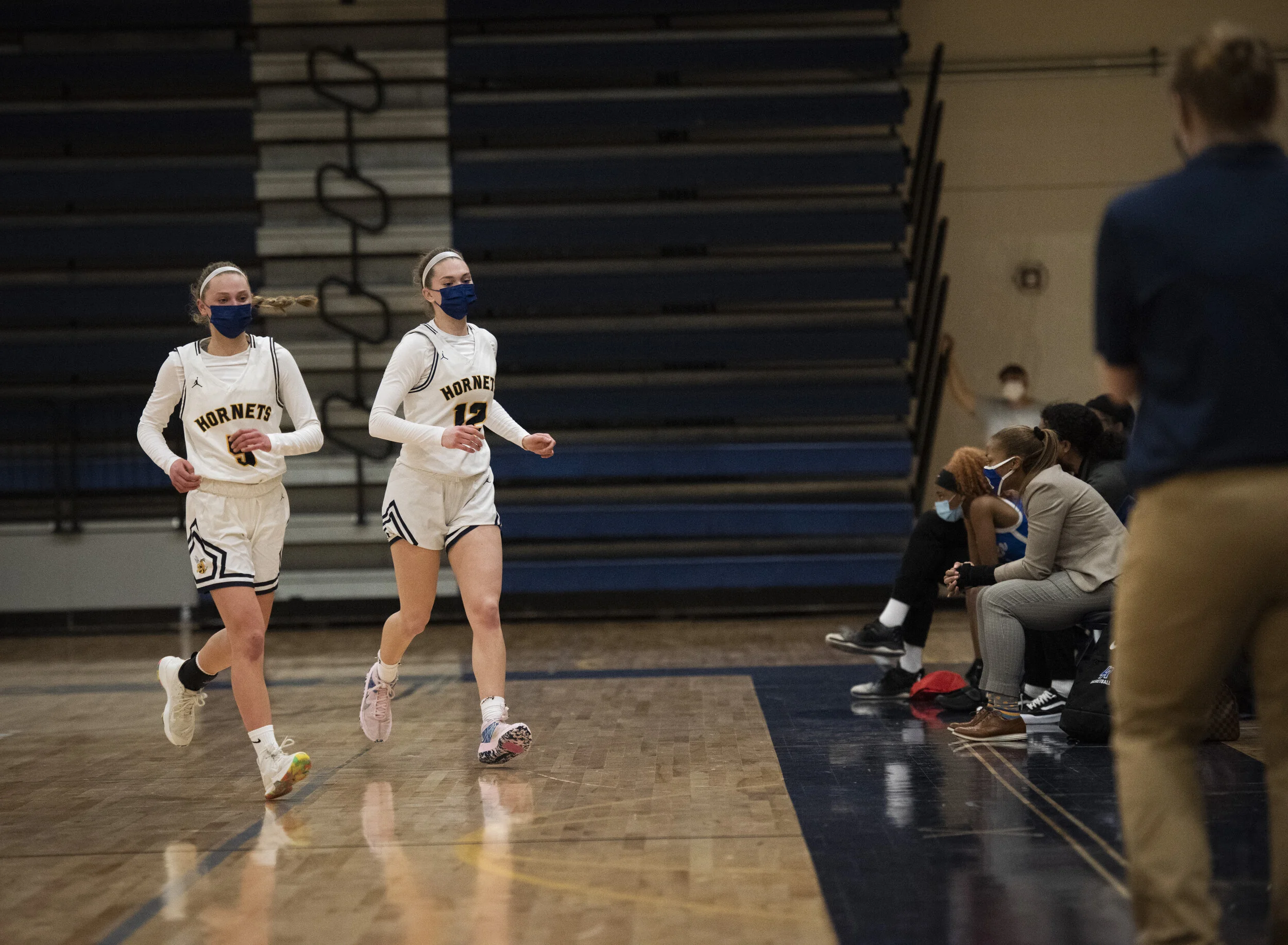  Kate, left, and Ella get taken out of the game by coach Leigh Ann Roehm, right, at home on Thursday, March 11, 2021. The Stemmer’s were taken out because the team was winning by over 30 points. Saline won 62-25. Roehm pulled Ella aside after the gam