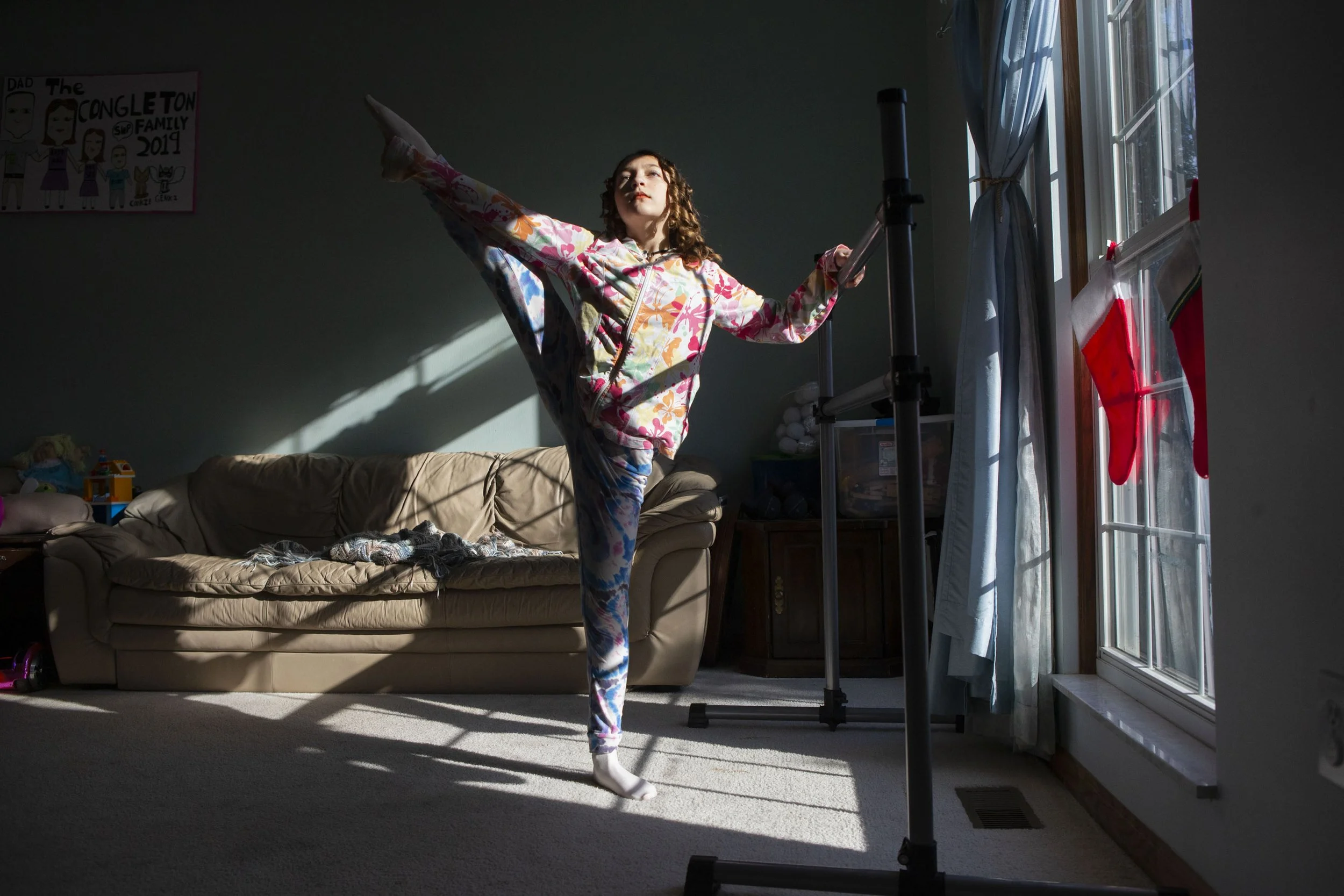  Phoebe Congleton, 12, stretches before ballet practice in her living room in London, Ohio, on Wednesday, Dec. 8, 2021. Congleton is a back up Clara in BalletMet’s production of the nutcracker this year. All participants in the nutcracker had to be 1