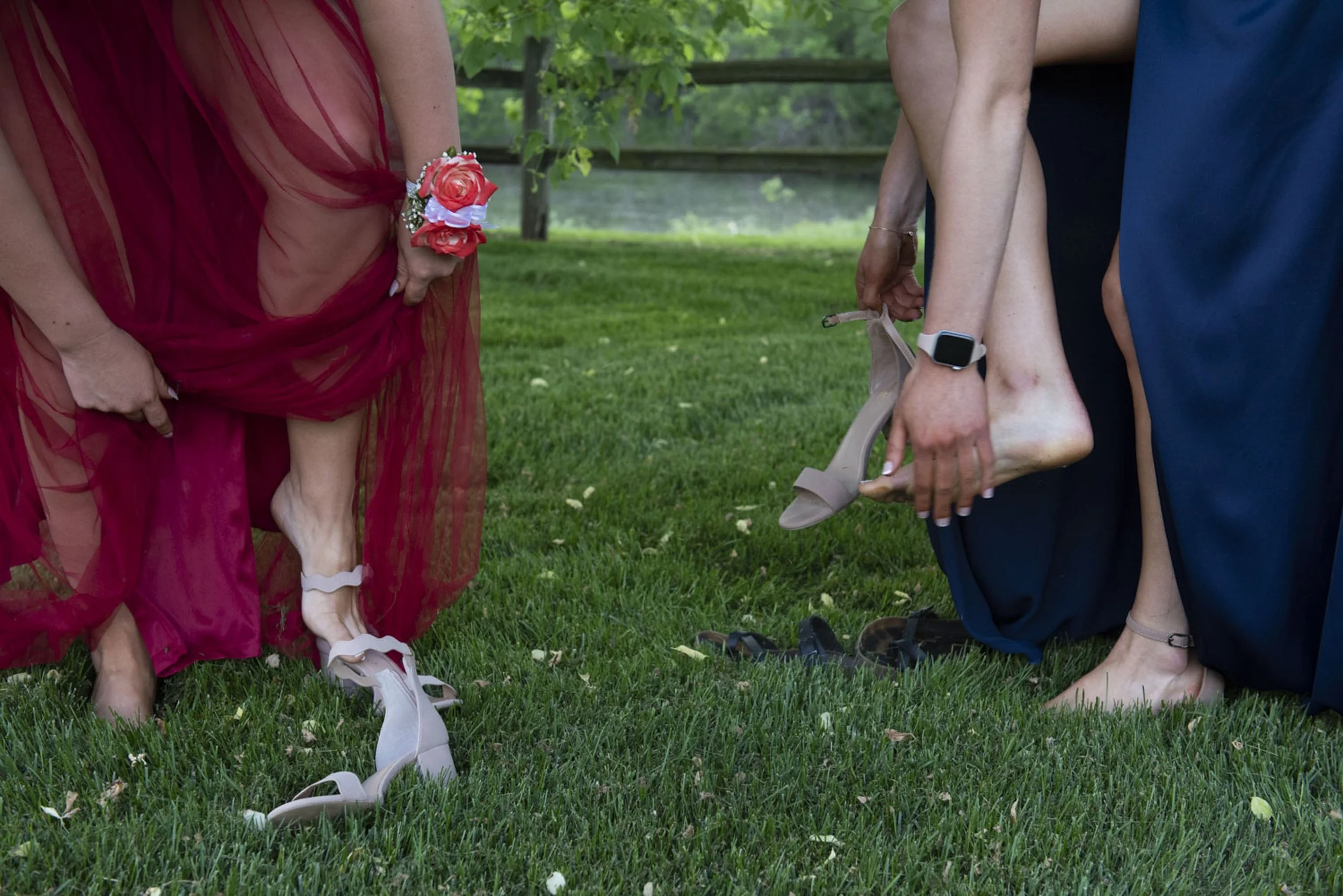  Saline seniors Abby Kruzer, left, and Ella Stemmer put on their shoes for before prom in Saline, Mich., on Saturday, May 22, 2021.  Saline High School prom was held outside in the grass. Stemmer leaves the next morning for college at Lehigh Universi