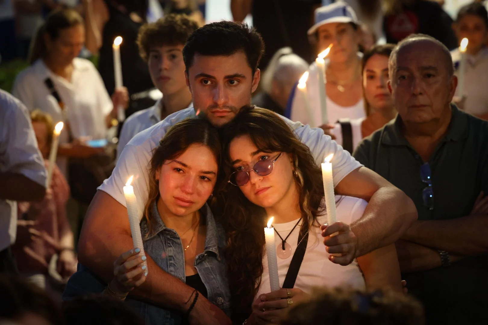  Isabella Green, left, and her sister, Nikita, share an embrace with Isaac Manton during a rally in support of the Israeli people in the Israel-Hamas conflict on Monday, Oct. 9, 2023, at Waterways Shoppes in Aventura.  