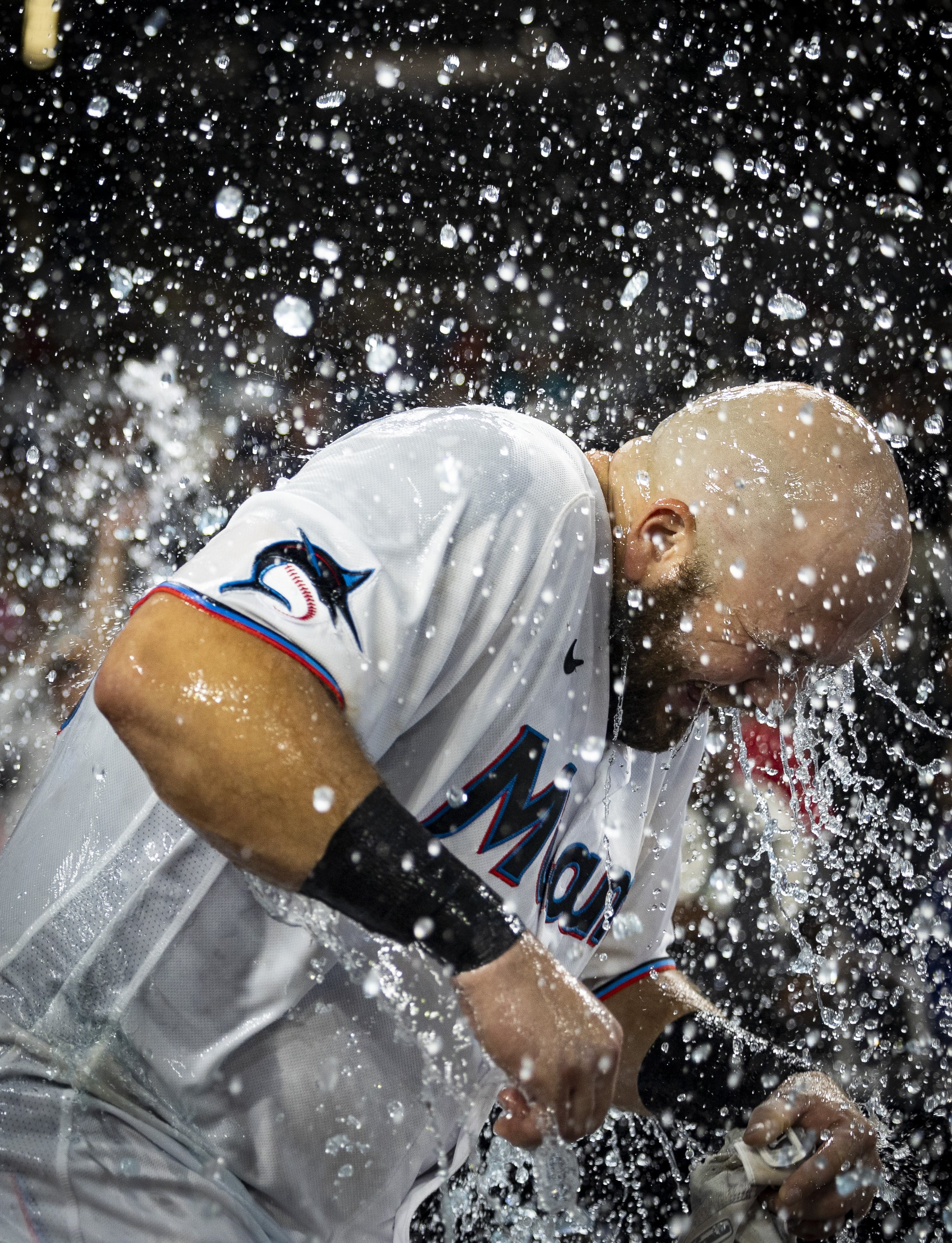 Miami Marlins third baseman Jake Burger (36) gets water dumped on him by teammates after hitting the game winning walk-off single against the New York Yankees during a baseball game on Sunday, Aug. 13, 2023, at loanDepot Park in Miami, Fla.