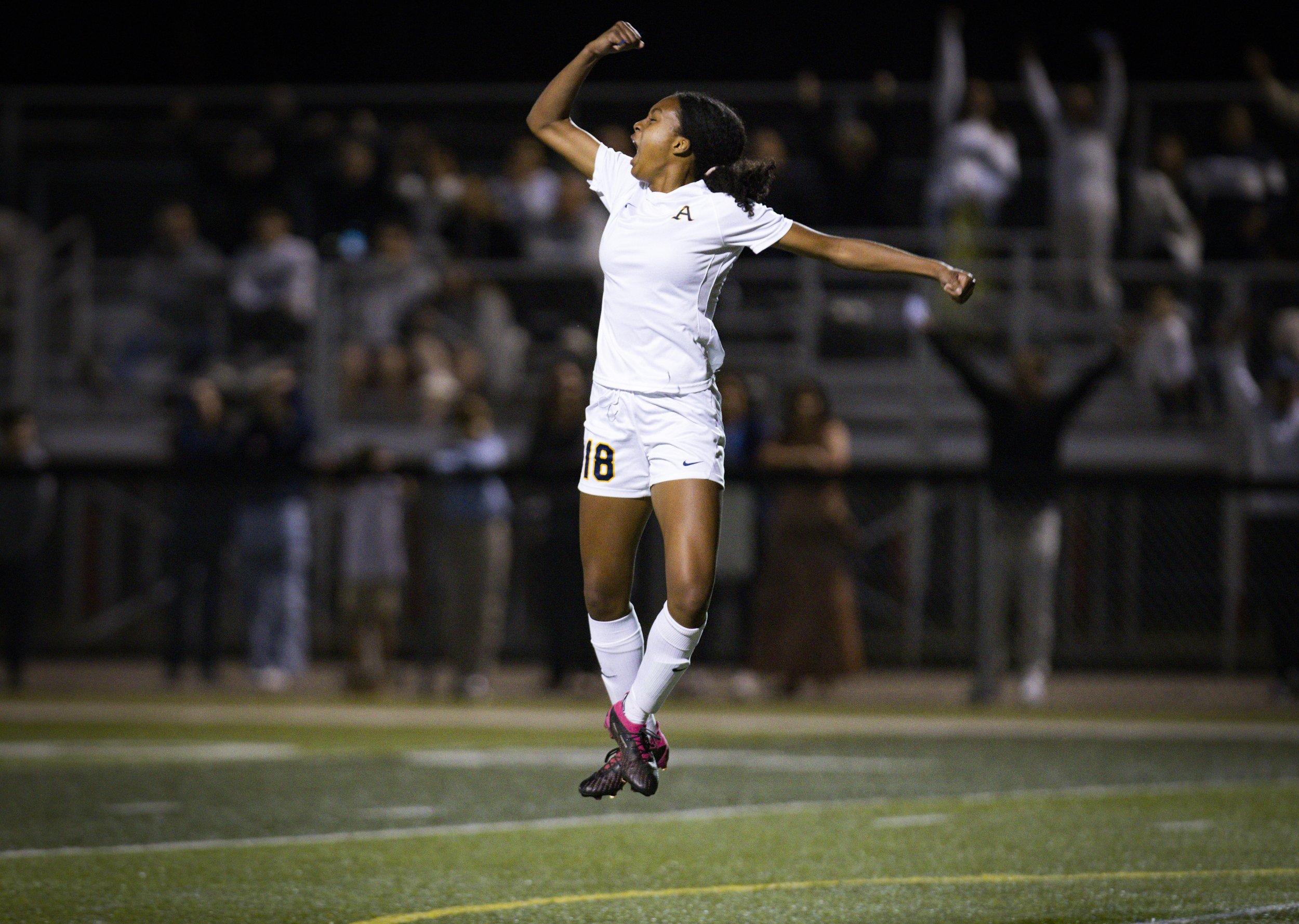 St. Thomas Aquinas’ Sophie Barnes (18) jumps up cheering after scoring a goal during the second half of the regional soccer final against Our Lady of Lourdes on Wednesday, Feb. 21, 2024, at Columbus High School in Miami.