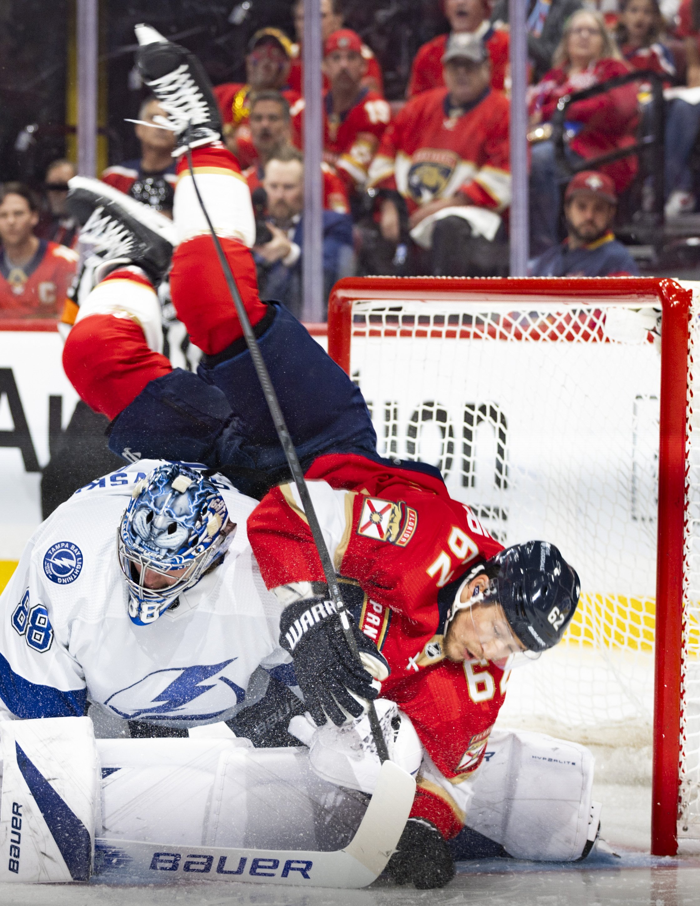 Florida Panthers defenseman Brandon Montour (62) falls over Tampa Bay Lightning goaltender Andrei Vasilevskiy (88) during the first period of Game 5 of Round 1 of the Stanley Cup Playoffs on Monday, April 29, 2024, at Amerant Bank Arena in Sunrise, F