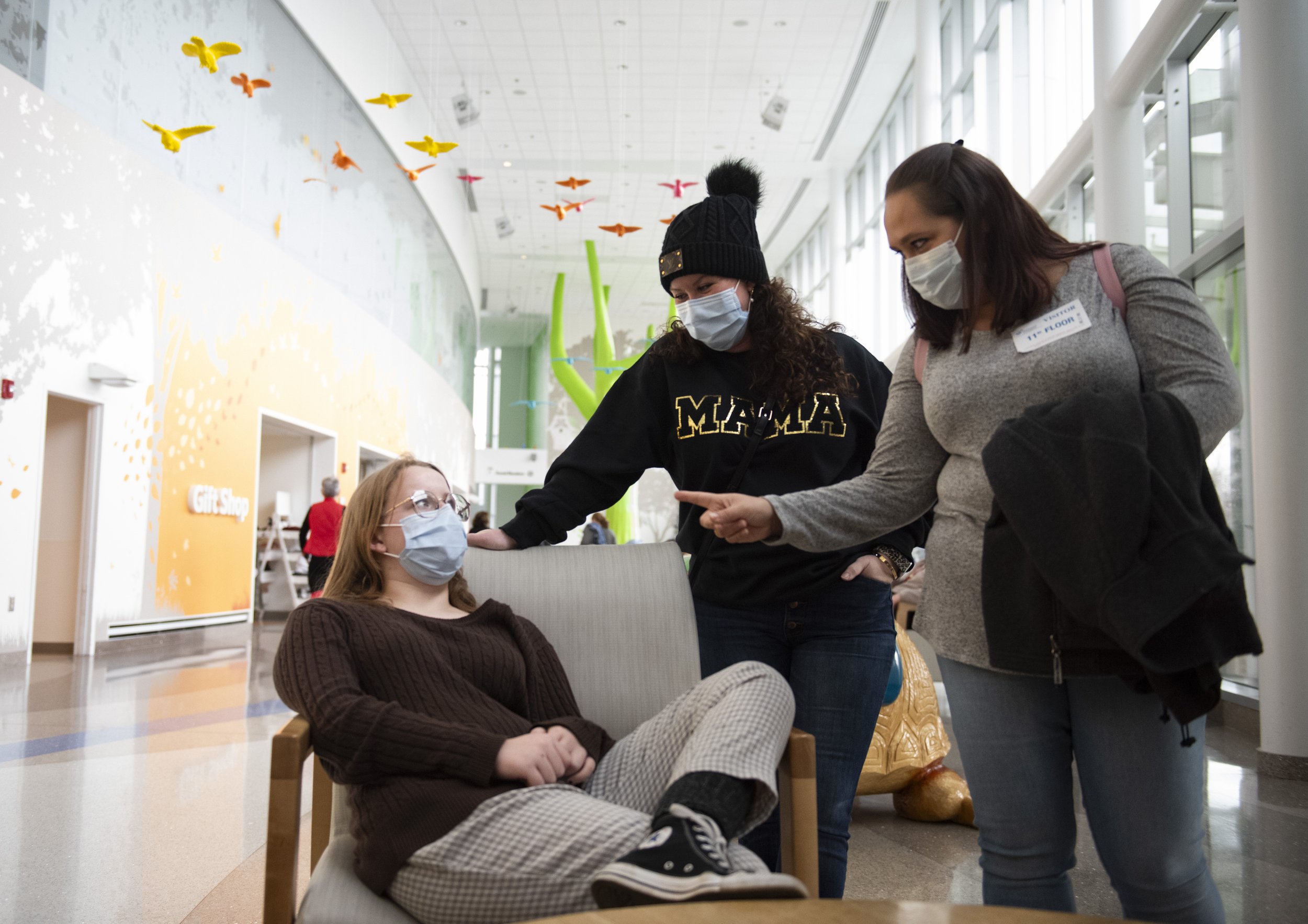 Kristy, Keira’s mom, right, make sure Joslynn tells her mother, Jodi, center, everything the doctors mentioned during Joslynn’s bi-yearly checkup at Nationwide Children’s Hospital in Columbus, Ohio, on Monday, Dec. 27, 2021. The families worked with