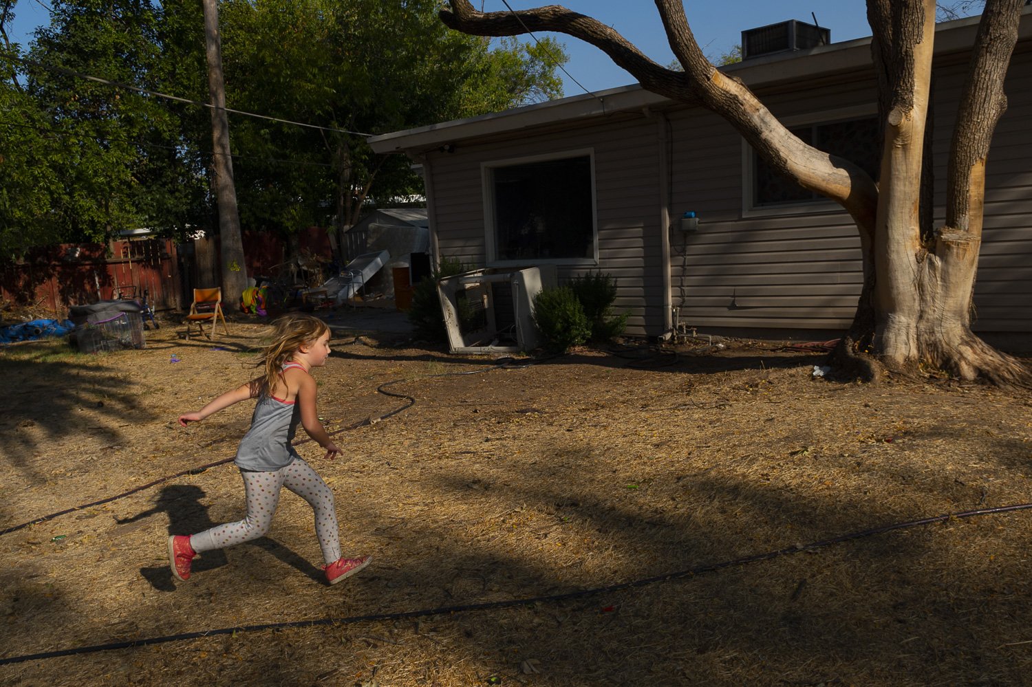 Lilly Harris runs across her backyard by herself while her mother, Crystal, recovers inside from a stress induced seizure. The six-year-old is often left to her own devices. “I like to help mom out with chores when she’s feeling sick. I like her to b