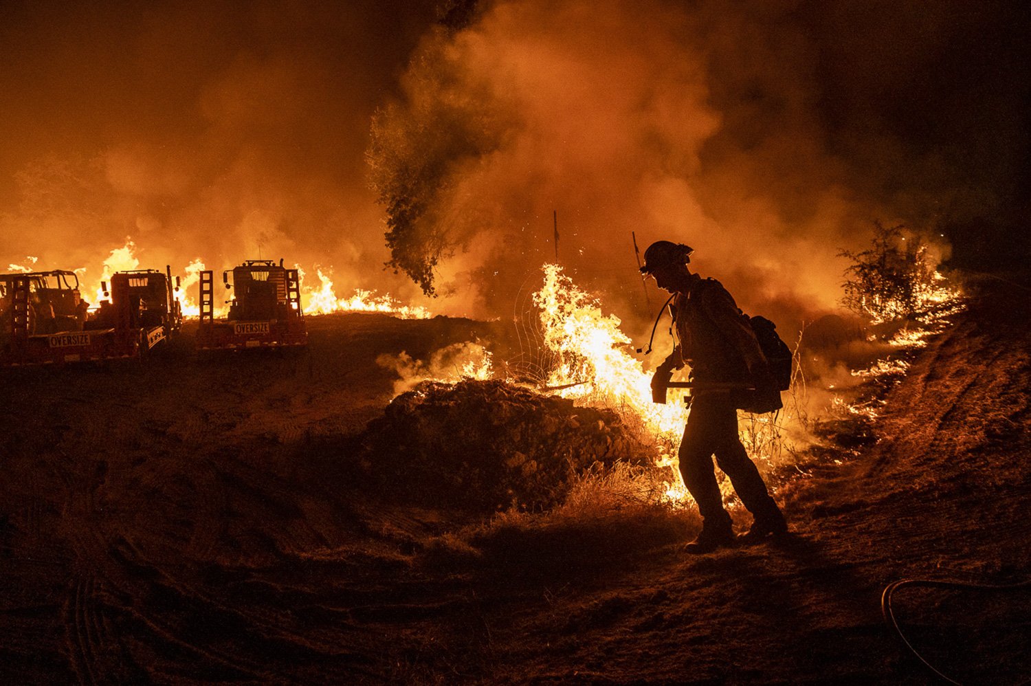 A firefighter heads back into the flames of the Sites fire while it burns across the mountainside in Stonyford, Calif., on Sunday, August 2, 2020. The fire season was described by locals as feeling “worse than the years before.”