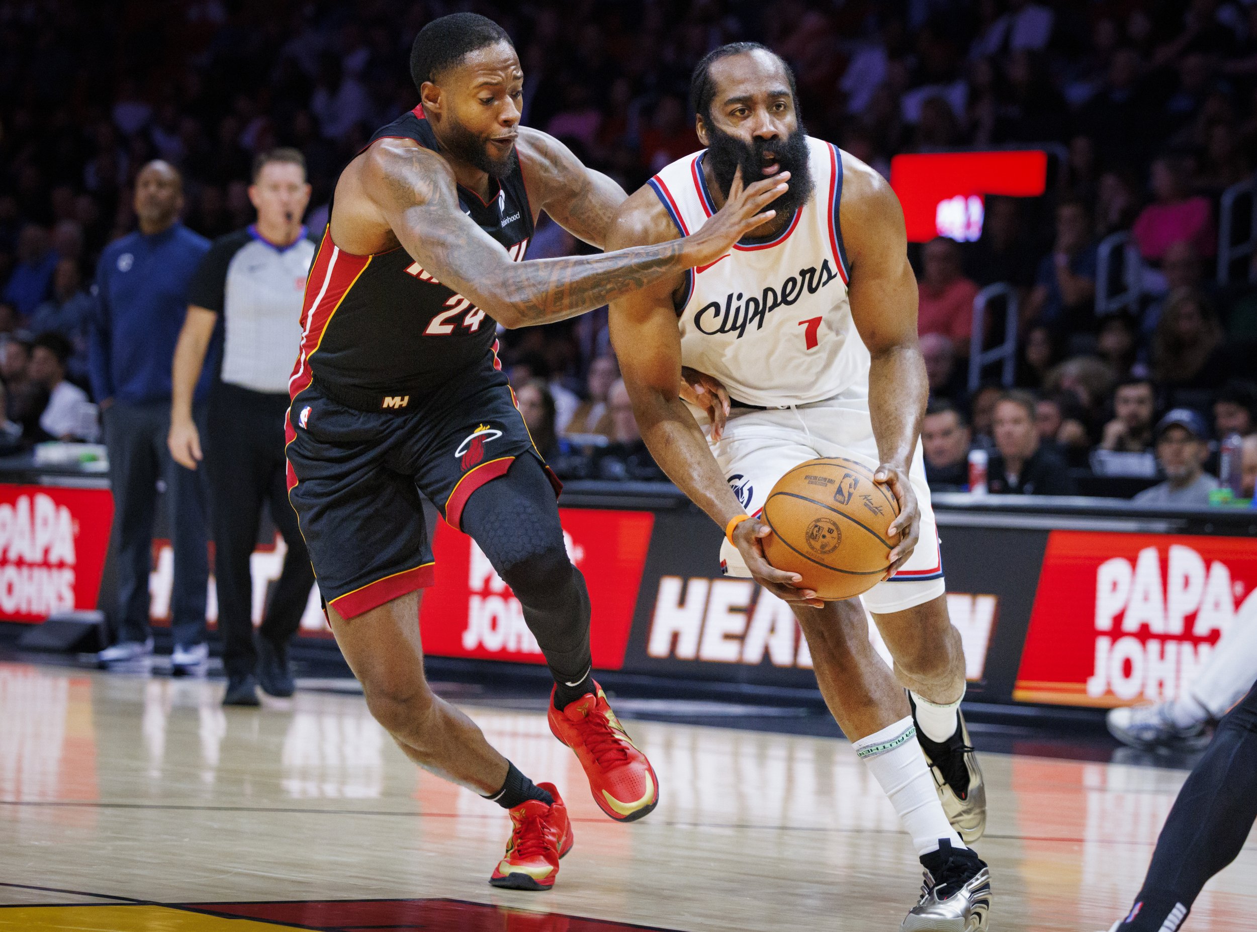 Miami Heat forward Haywood Highsmith (24)
hits LA Clippers guard James Harden (1) in the face during the first half of a game on Wednesday, March 12, 2025, at the Kaseya Center in downtown Miami, Fla.