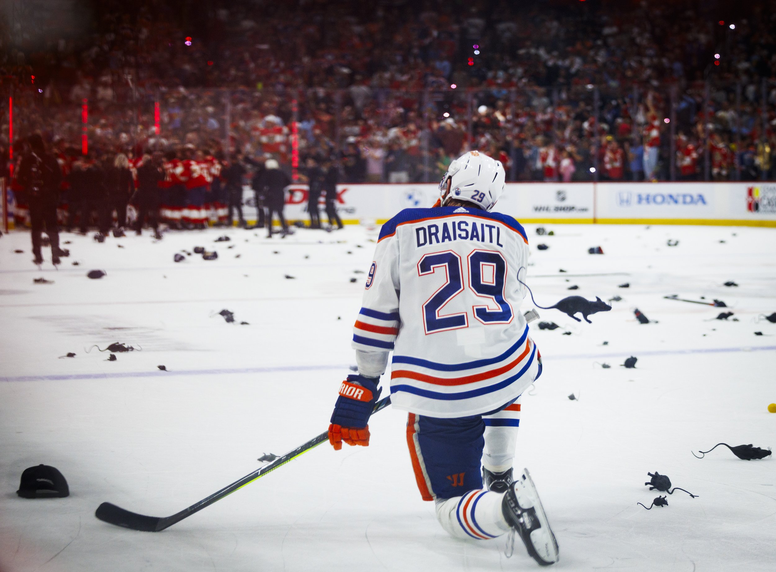 Edmonton Oilers center Leon Draisaitl (29) kneels on the ice among plastic rats as the Florida Panthers celebrate winning the NHL Stanley Cup Final against the Edmonton Oilers at the Amerant Bank Arena on Tuesday, June 25, 2024 in Sunrise, Fla.