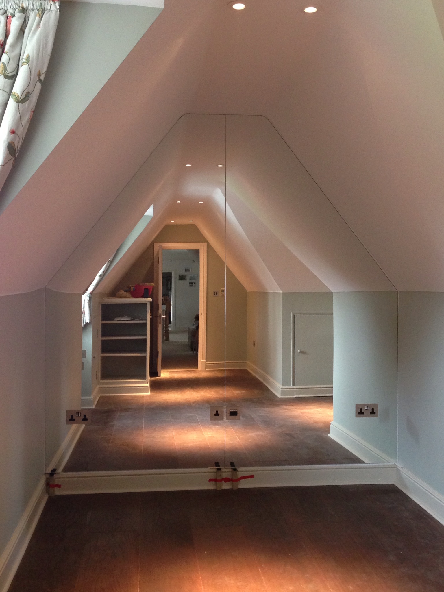 Bespoke triangular mirror for loft room