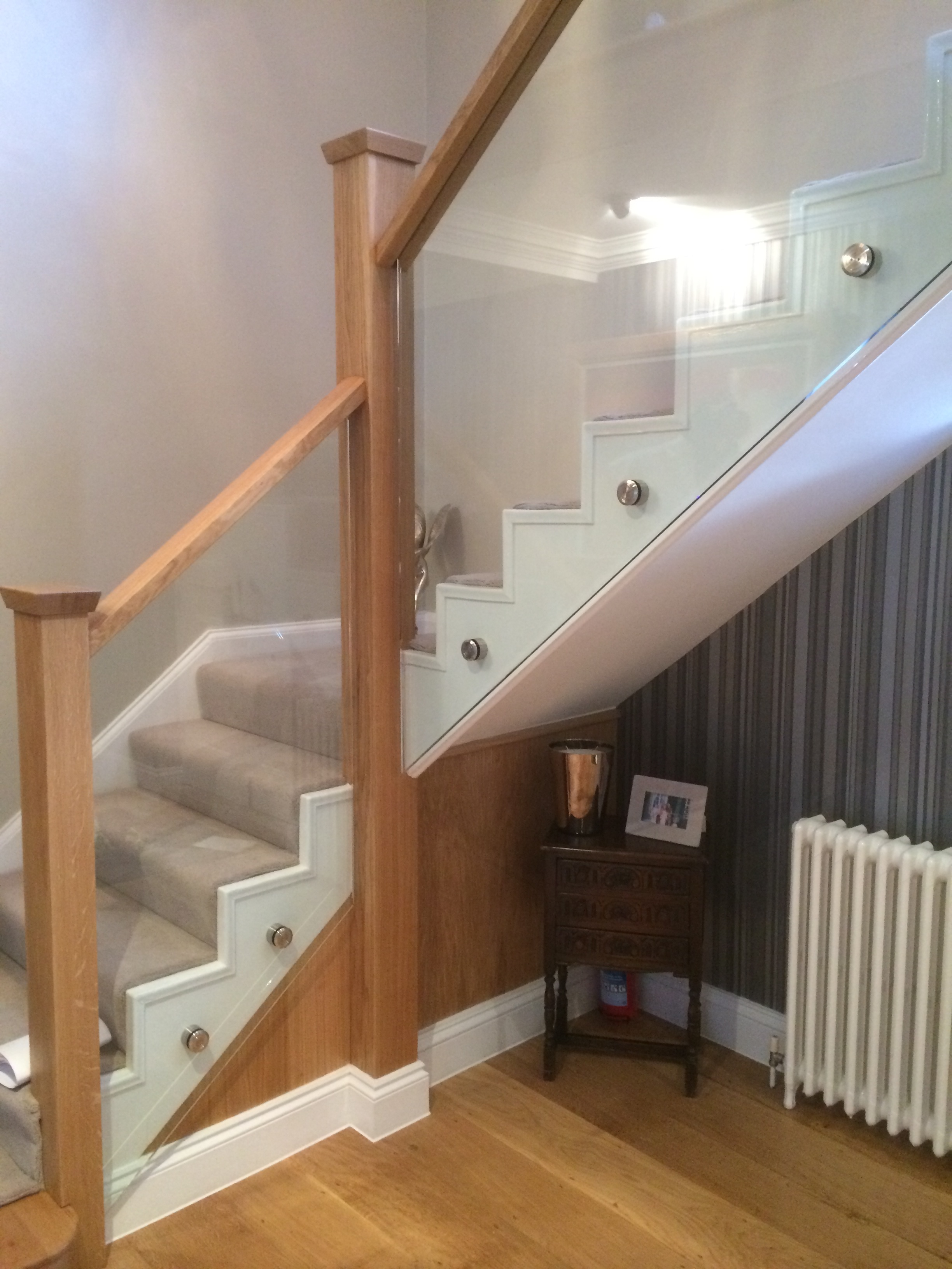Glass stair balustrade with oak hand rail in St Albans
