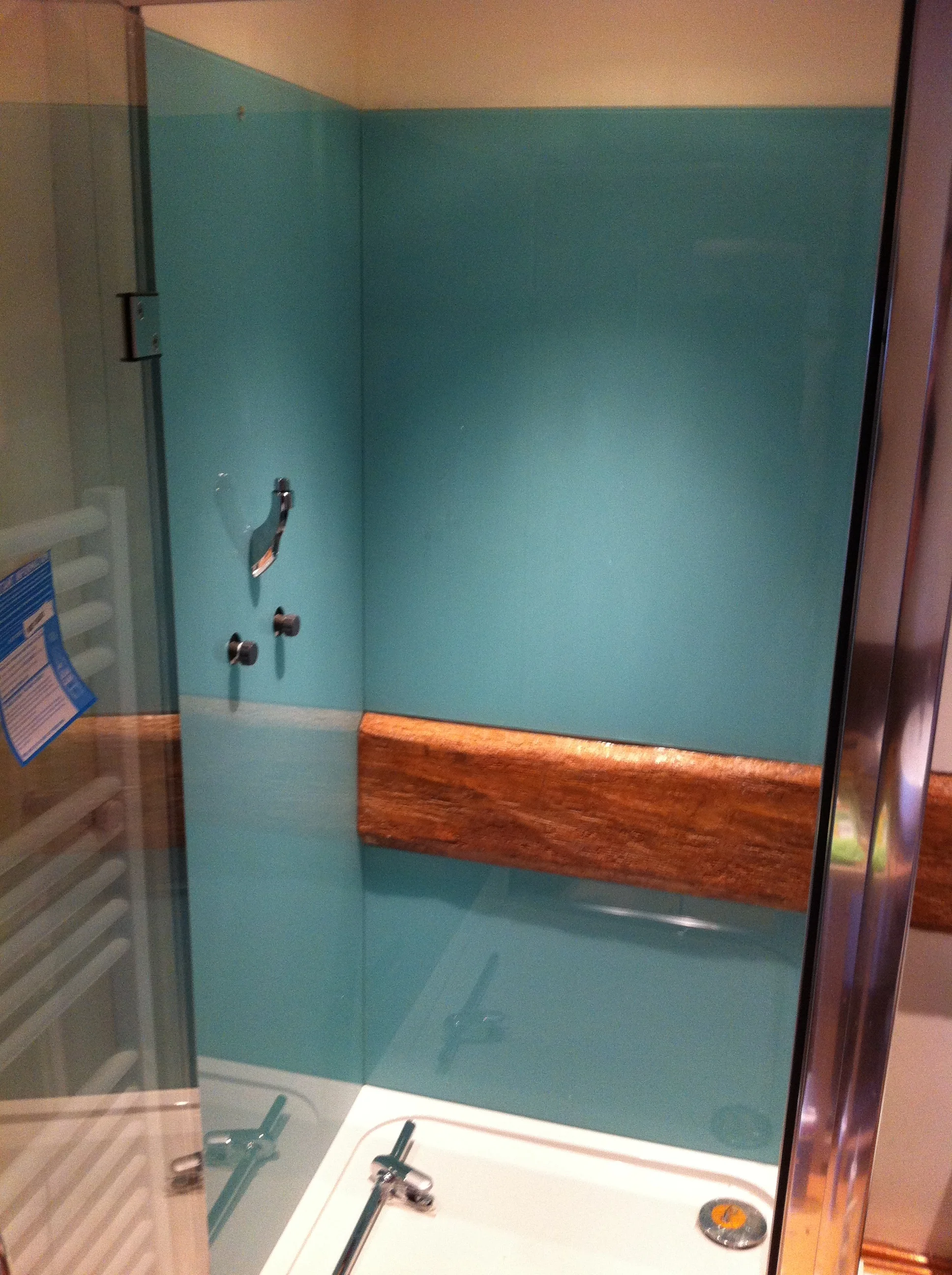 Blue glass shower splashback