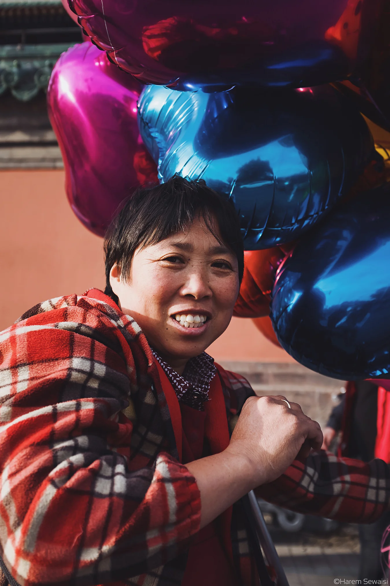 She is selling colorful balloons. Beijing, China