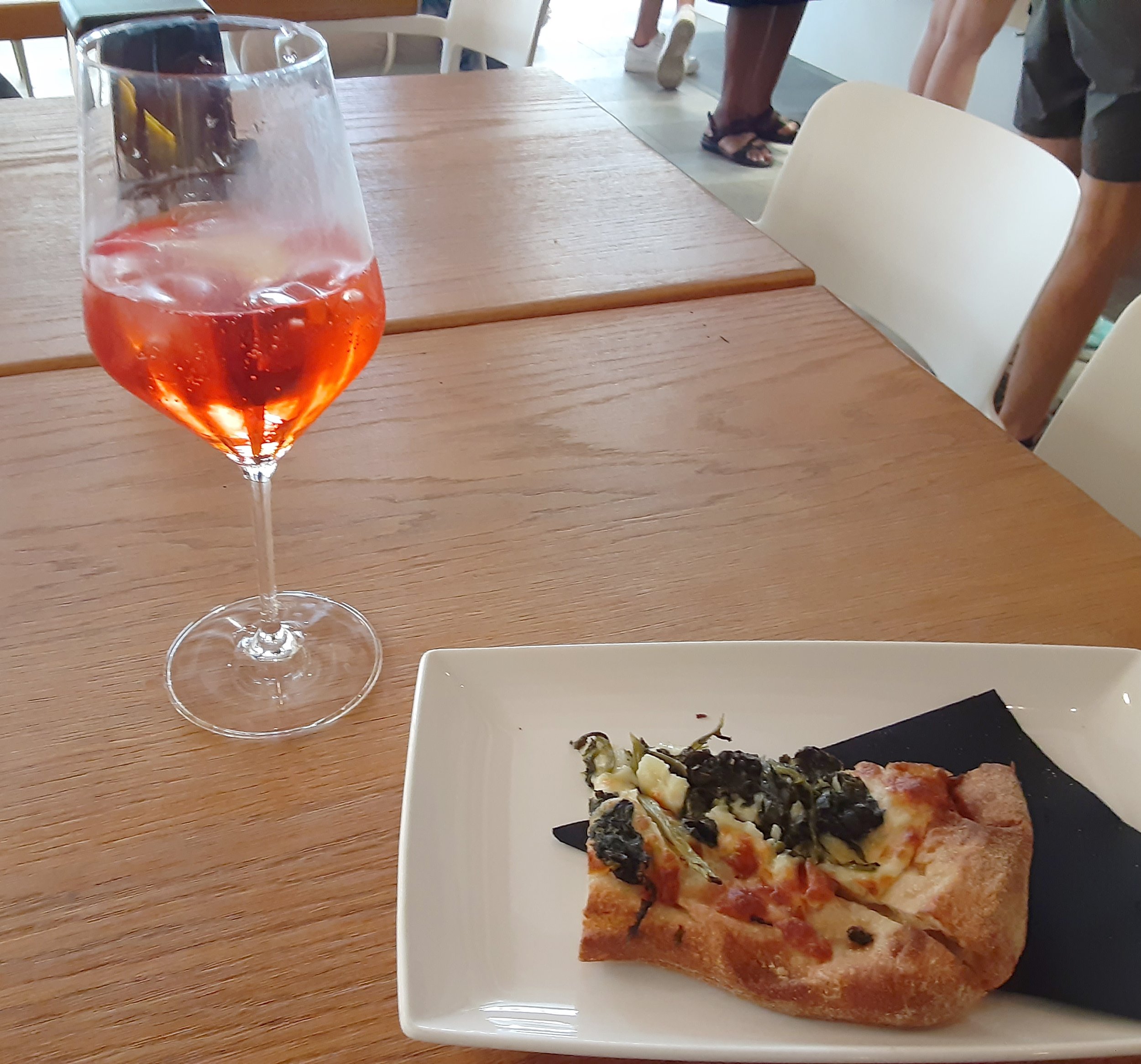 Half finished pizza and spritz 
