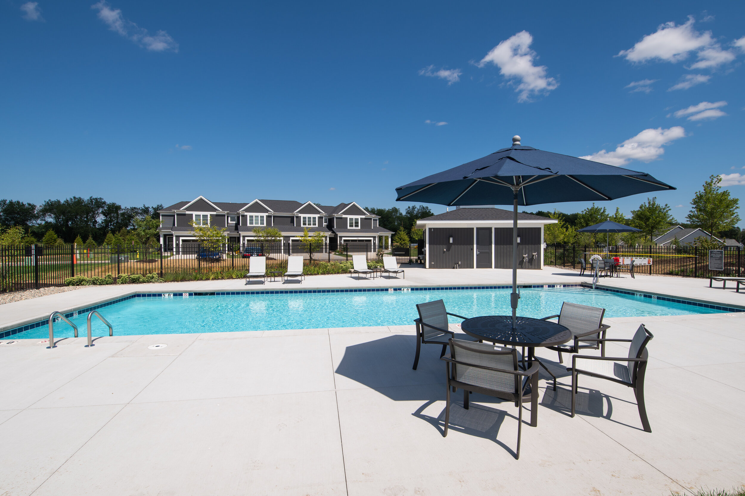 community pool with patio furniture