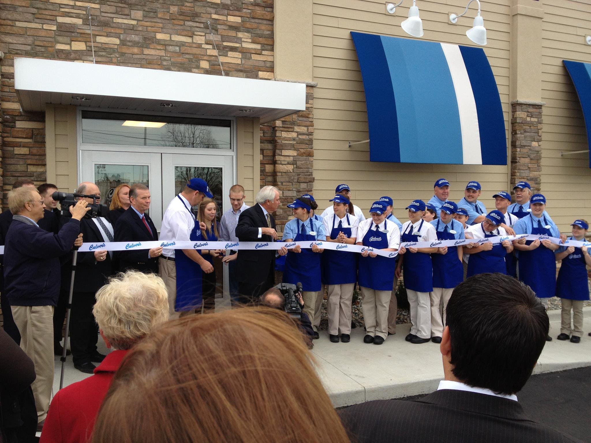 Craig Culver, Michael Miller and team cut ribbon at the new Coldwater, Michigan Culvers Monday October 29 2012.jpg