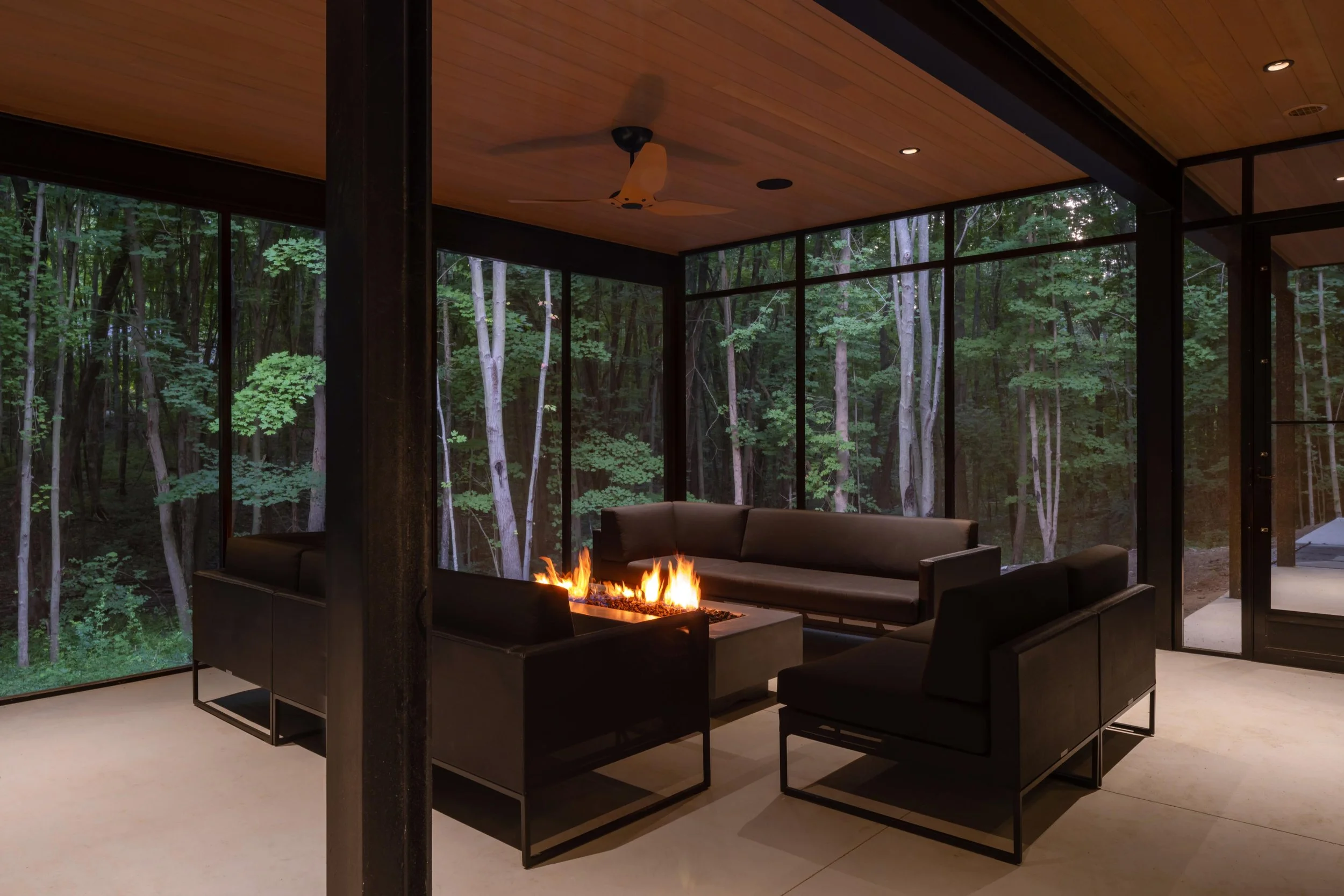 CUS-21-050 Custom Screened Porch Firetable in evening.jpg