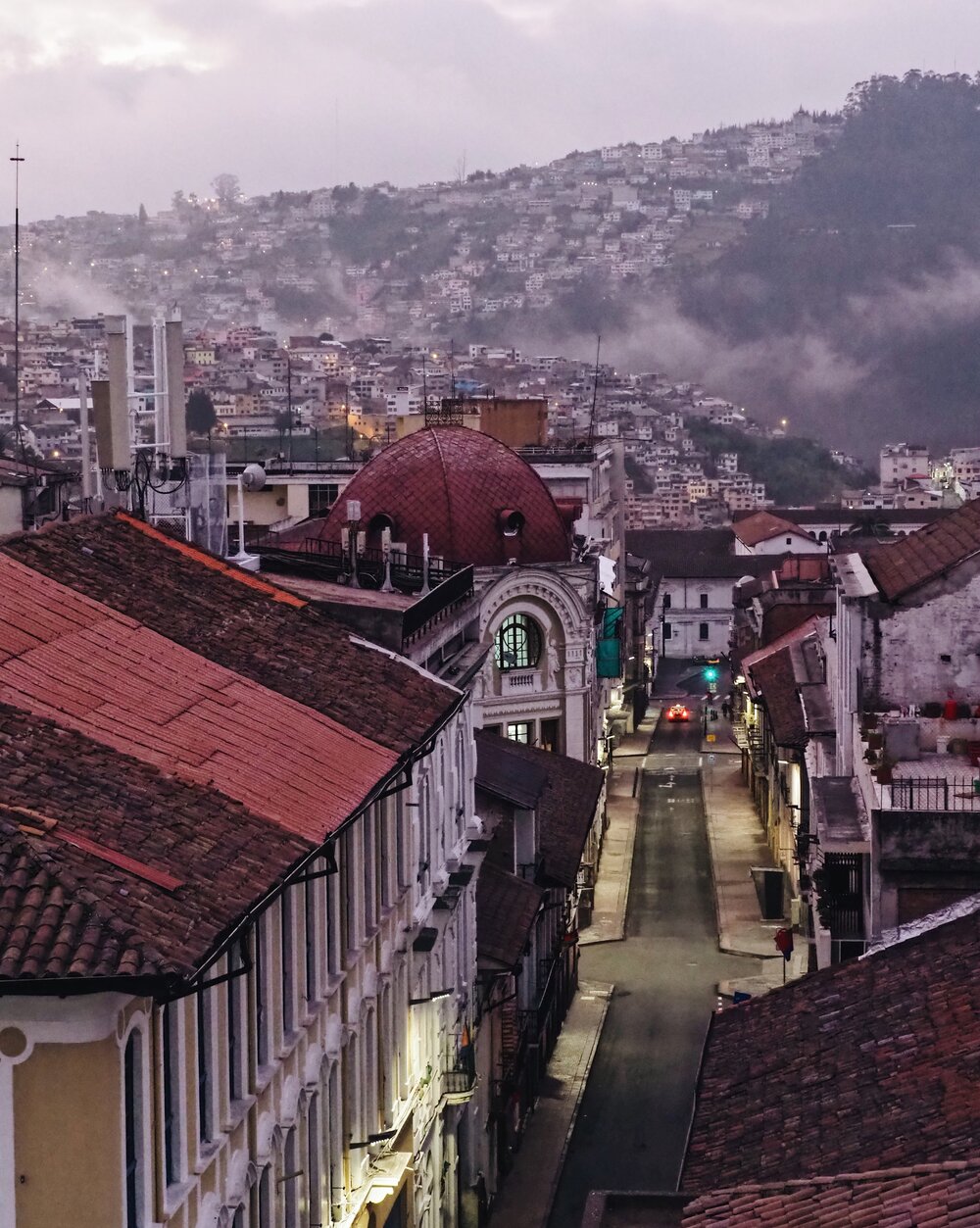   Old Town Quito - seen from  Casa Gangotena ’s roof terrace in the magic purple light before sunrise  