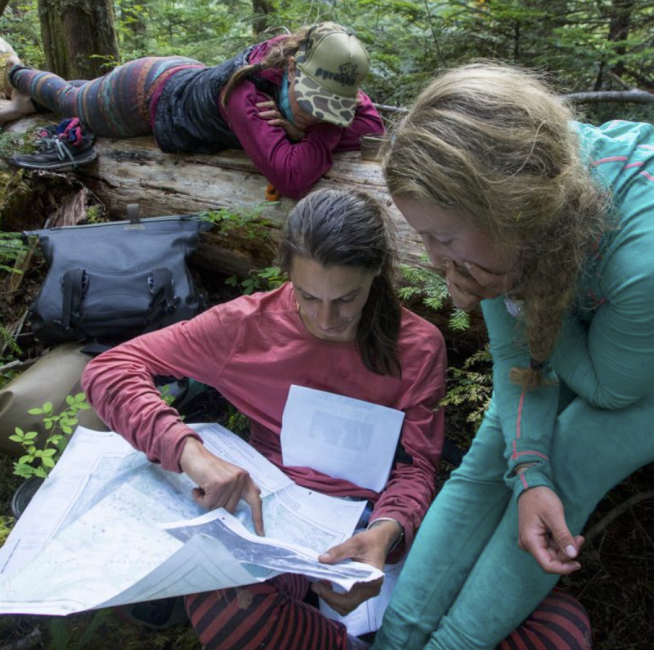 The group assess their options after reaching an impassible tributary that is blocking them from reaching a logging road, their lifeline out. Photo: Maranda Stopol.