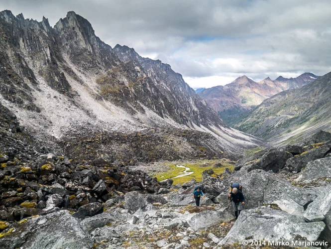 Author Lyn Elliot and Peter Knamiller climbing out of the boulder-filled Valley of Chaos.