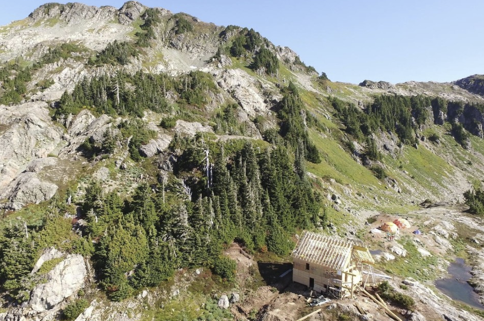 Drone shot of the hut under construction, and the mess tents beyond.