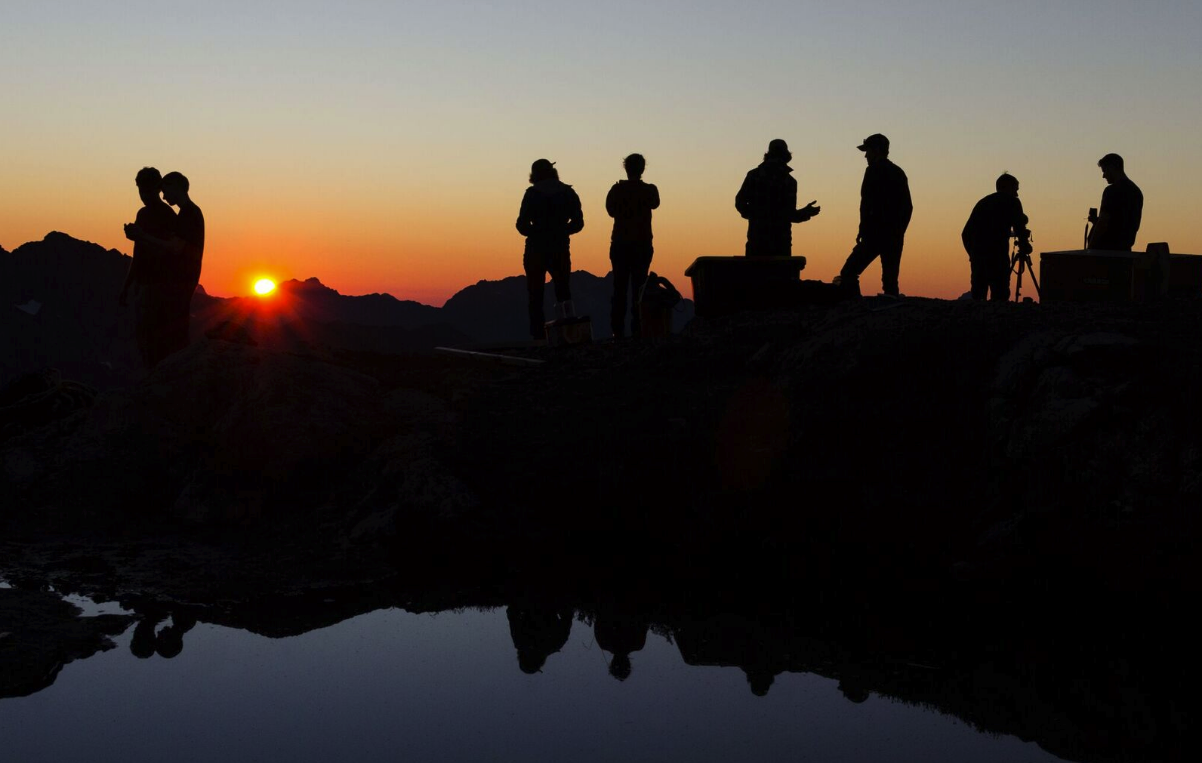 Volunteers and videographers at sunset. We had clear skies and great views for the final weekend of construction. Photo by Chris George.