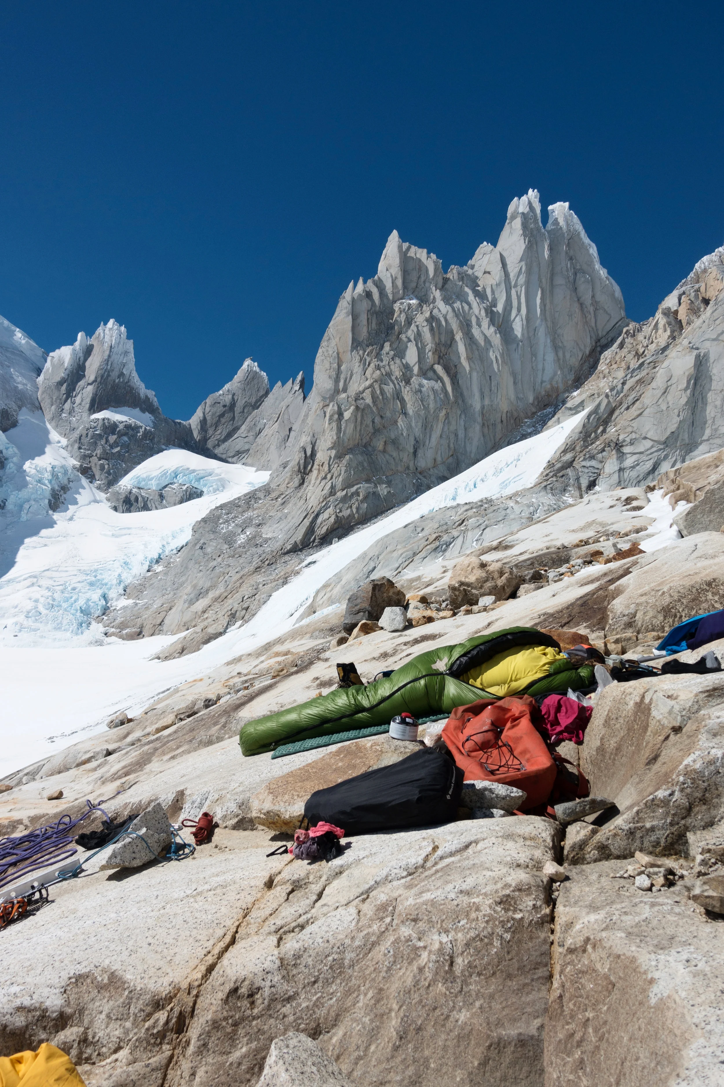 Resting in the sun after living in snow for two days! Letting the gear dry out and the temperature cool down before we continue up Cerro Torre West Face. Photo by Michelle Kadatz.