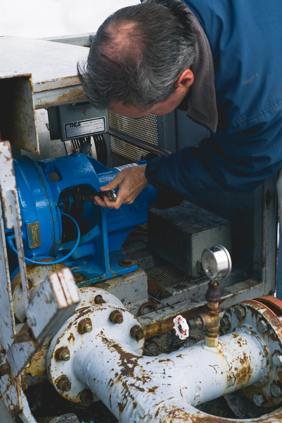 After some serious digging and excavation of the turbine and water hose, Tom checks to make sure the valves and belt are in working order.