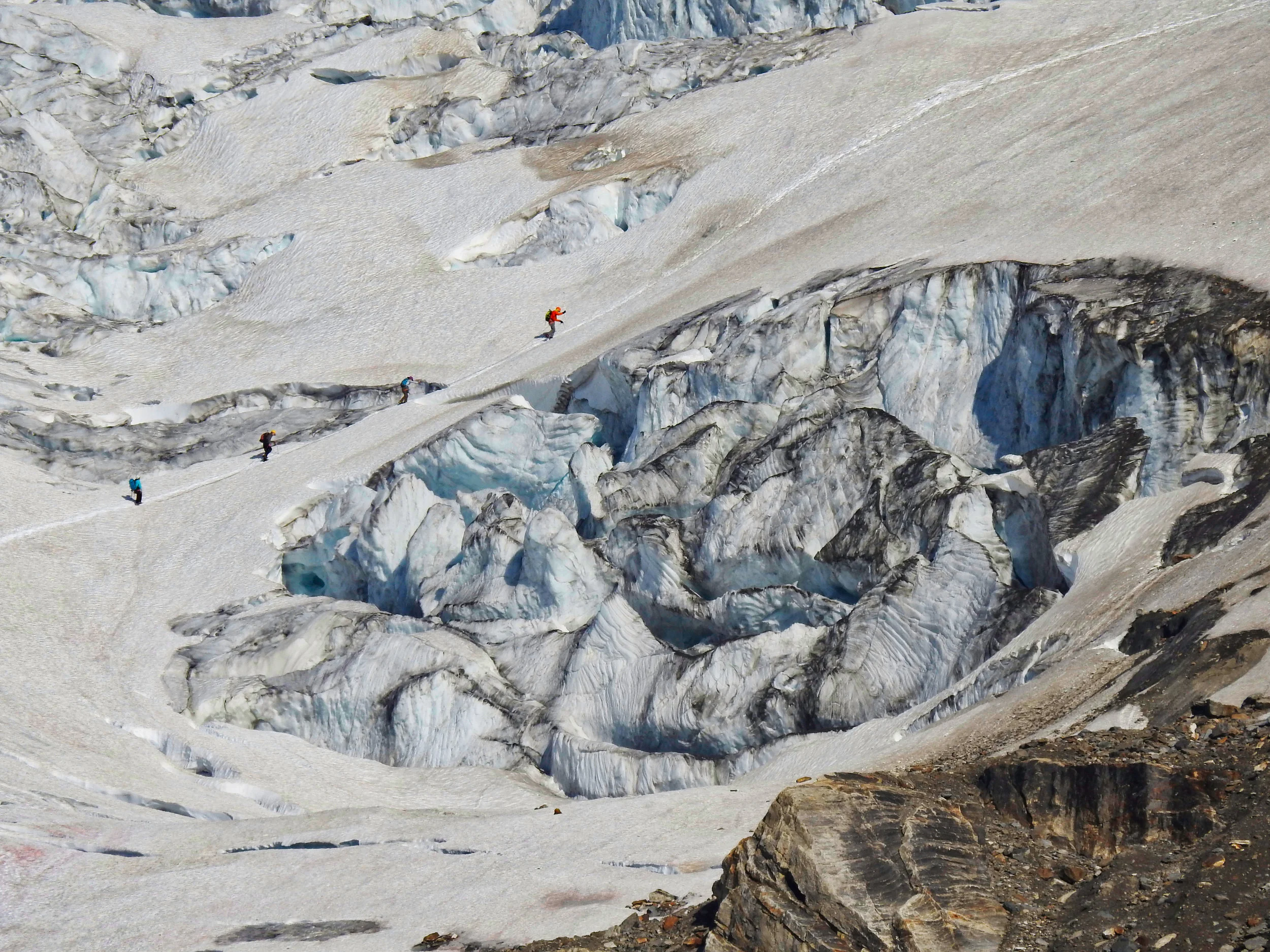 A rope team led by amateur leader Rob making its way past some large seracs that were partway up the Riddle Glacier. I took this shot from camp during my rest day. The scale of this glacier was hard to wrap your head around, I like how small the climbers look compared to the massive ice cliffs. Photo: David Servos.