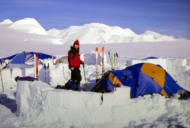  Tony at base camp elevation 3535m., with Mt. Lucania, 5260m main summit in the far distance centre of photo. Photo by Bill McKenzie. 