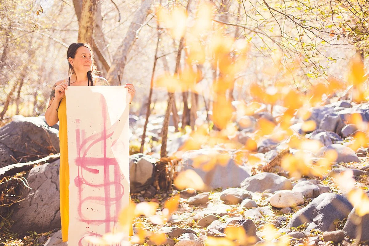 Jill Sans holding canvas with blackberry ink. Standing in Oak Creek Canyon, Arizona