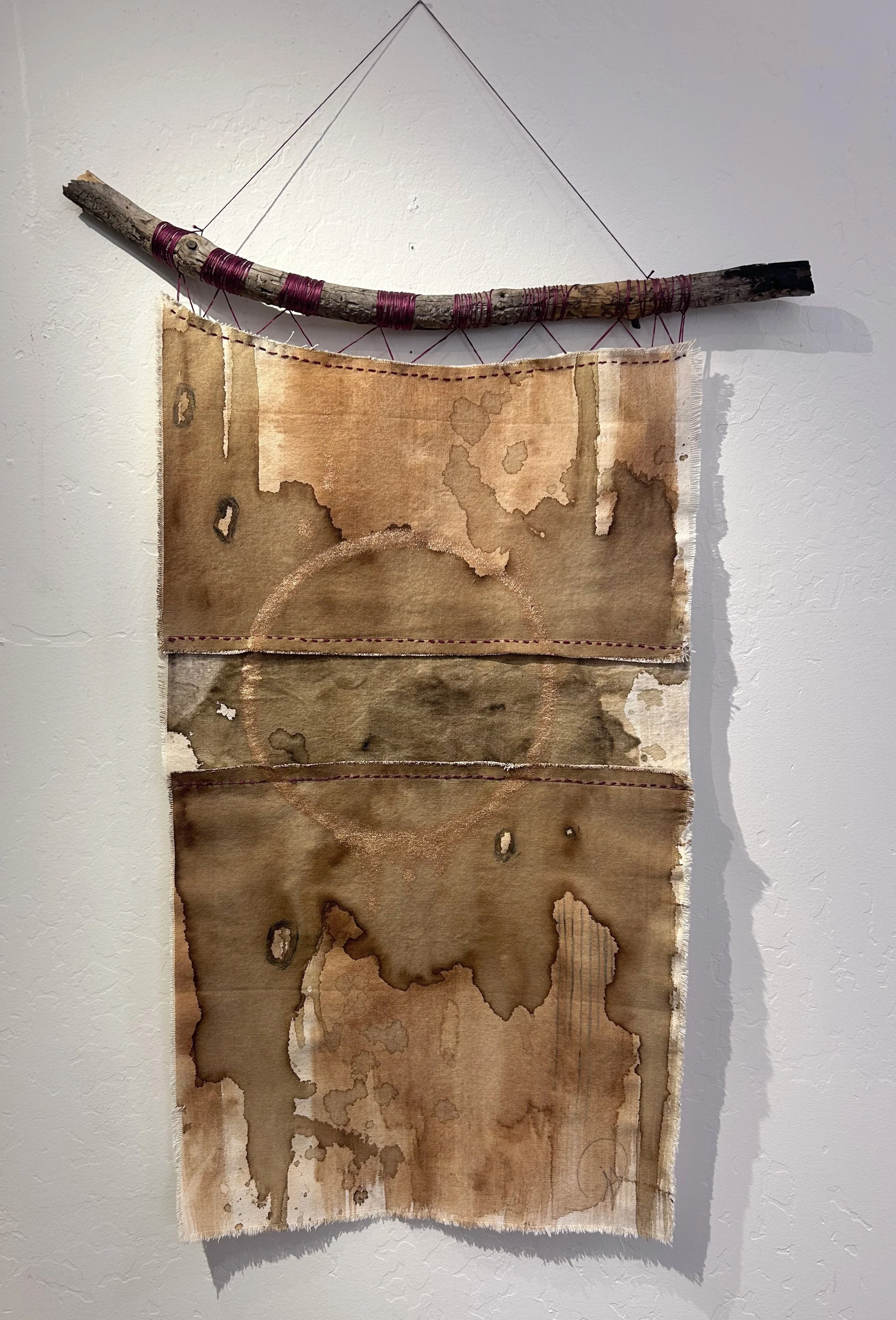 Ponderosa ink and coffee ink on raw canvas with copper mica. woven to a ponderosa pine branch
