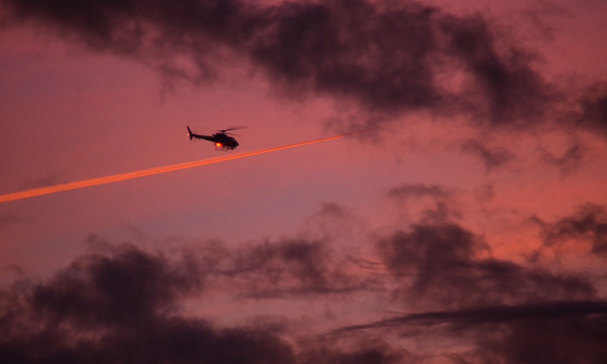 Helicopter and Contrail at Sunrise